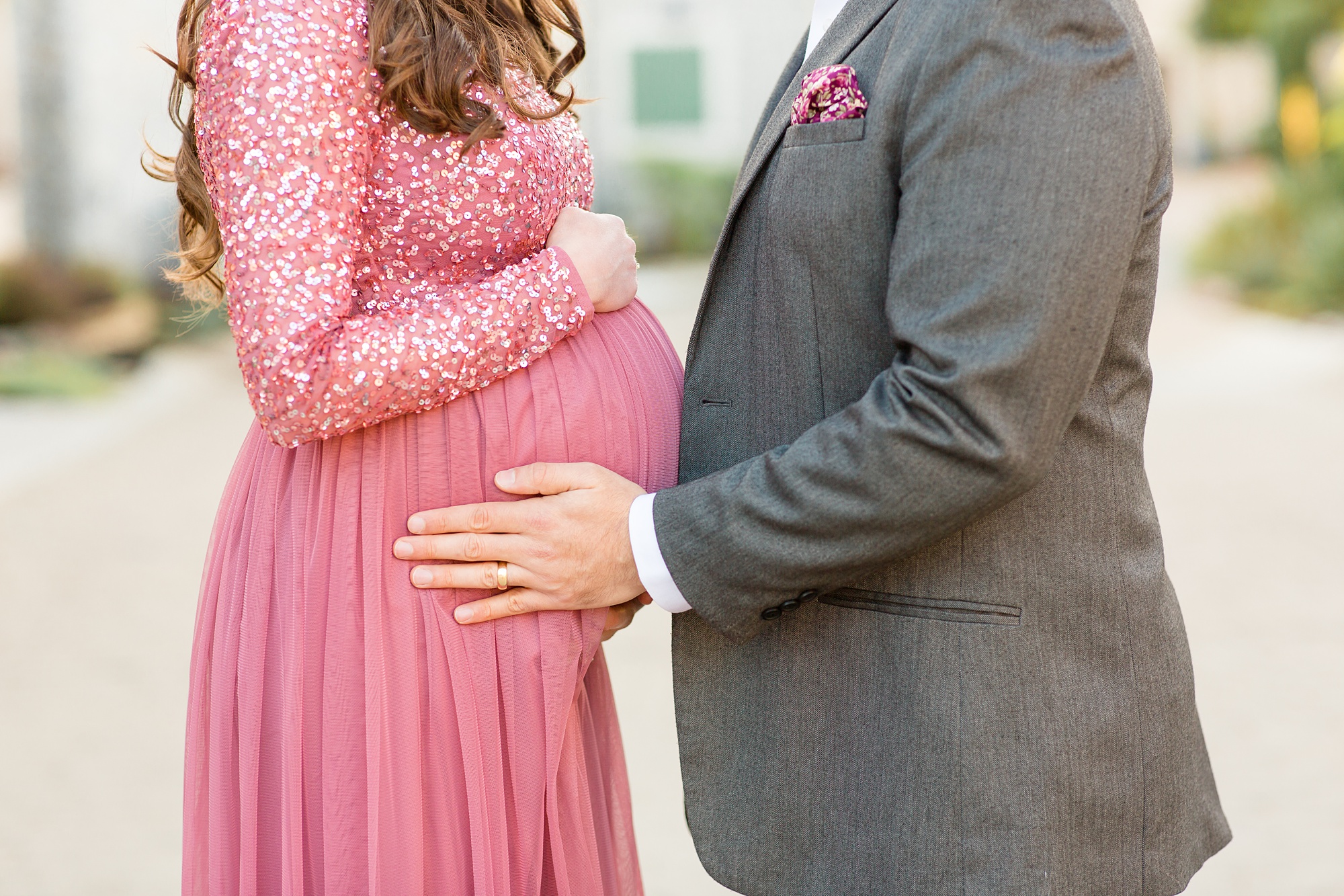 dad holds mom's belly during maternity session