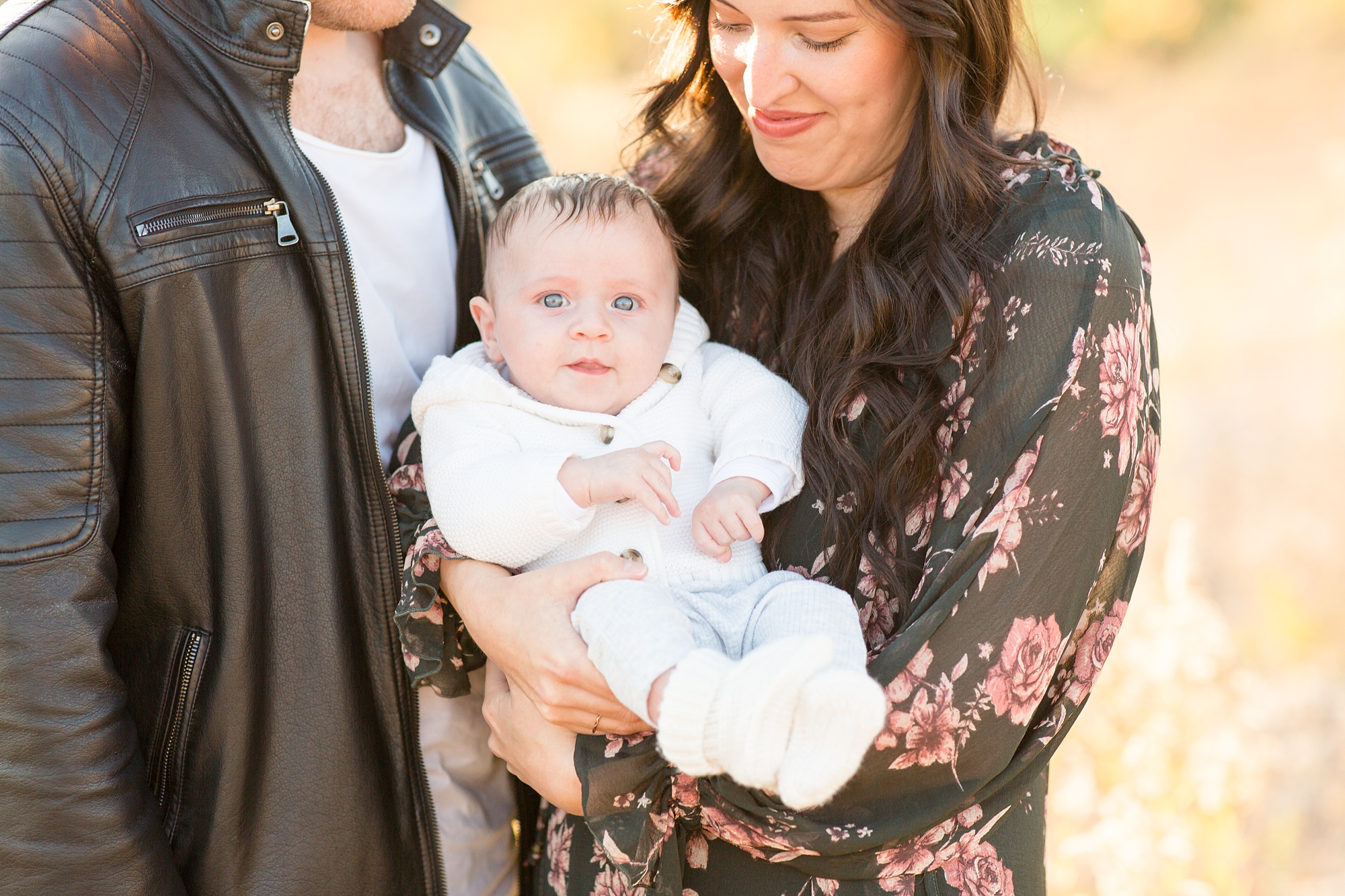 mom and dad hold baby during Nashville family portraits