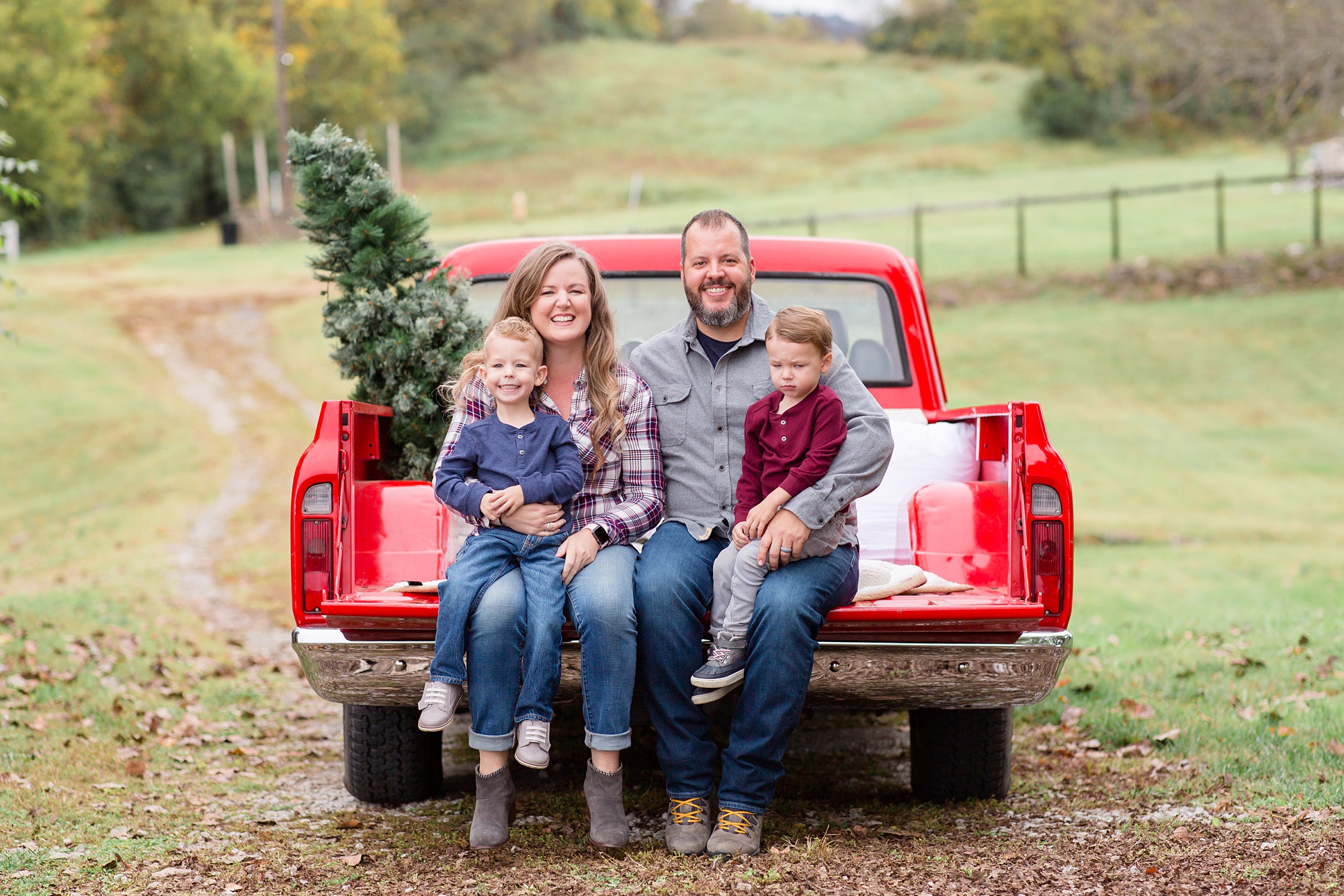 family of five sits on truck bed during Tennessee Red Truck Christmas Minis