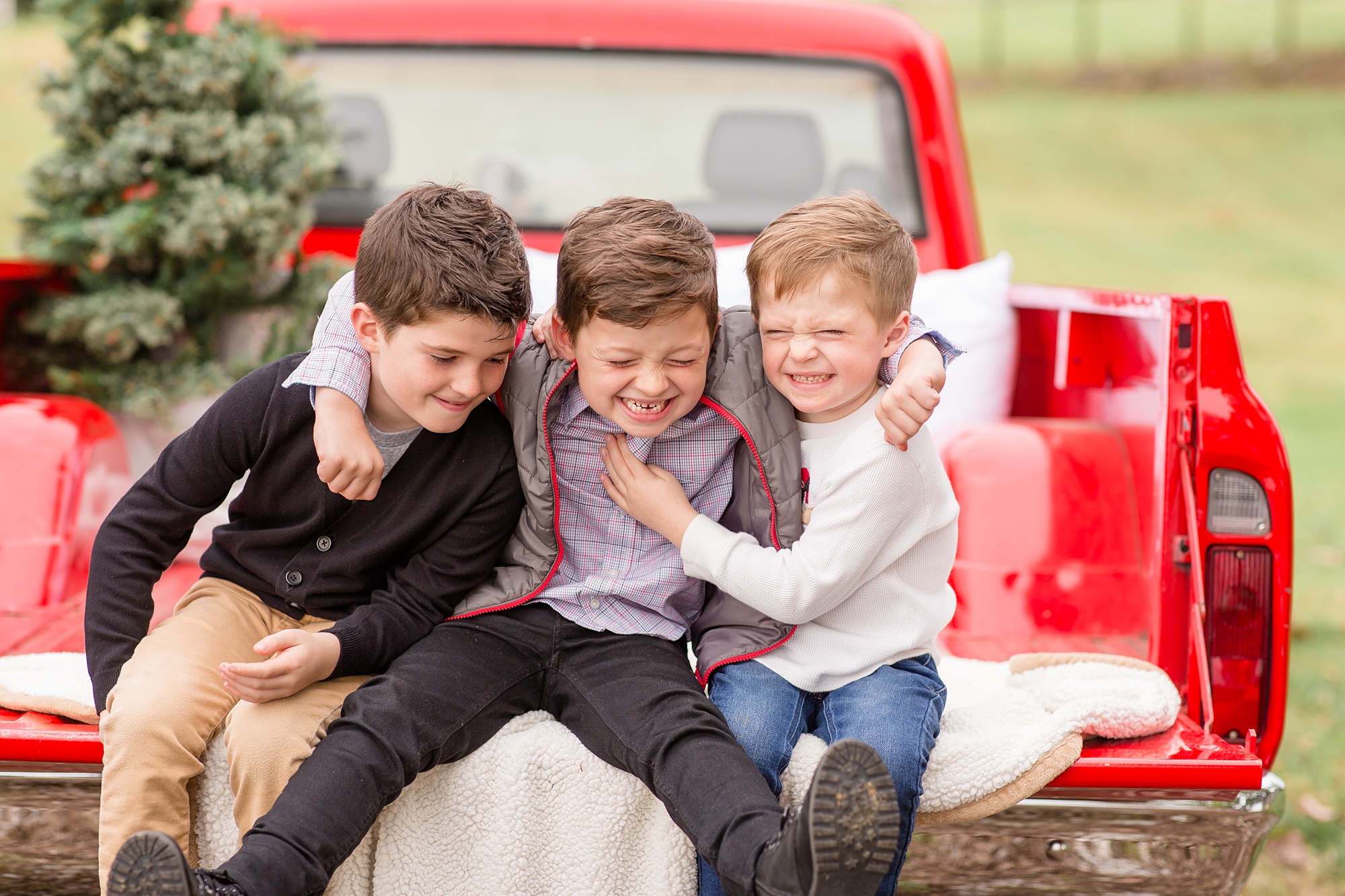 three brothers hug during Christmas minis with Rebecca Rice Photography