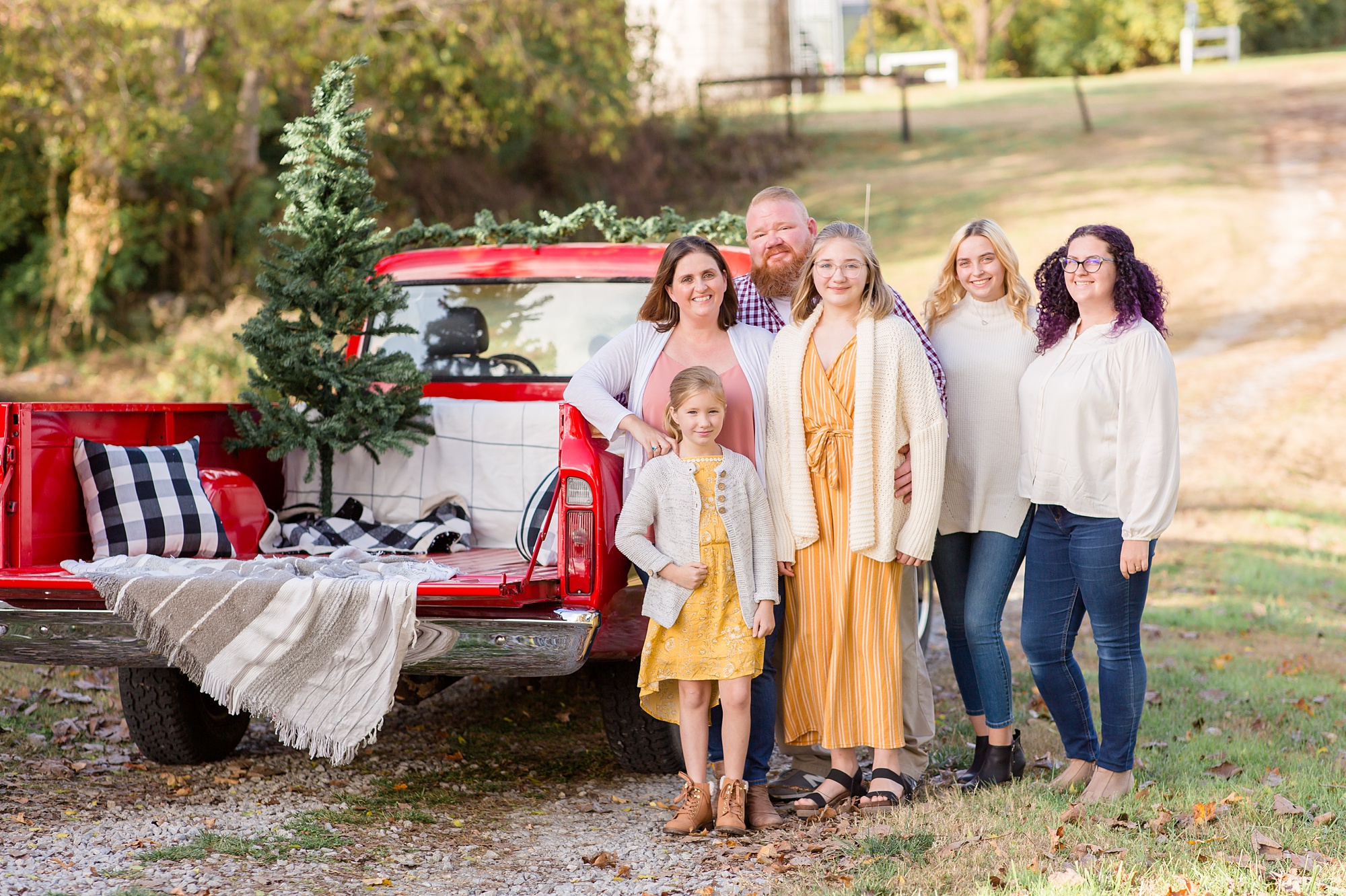 family of six poses by red truck in Nashville TN