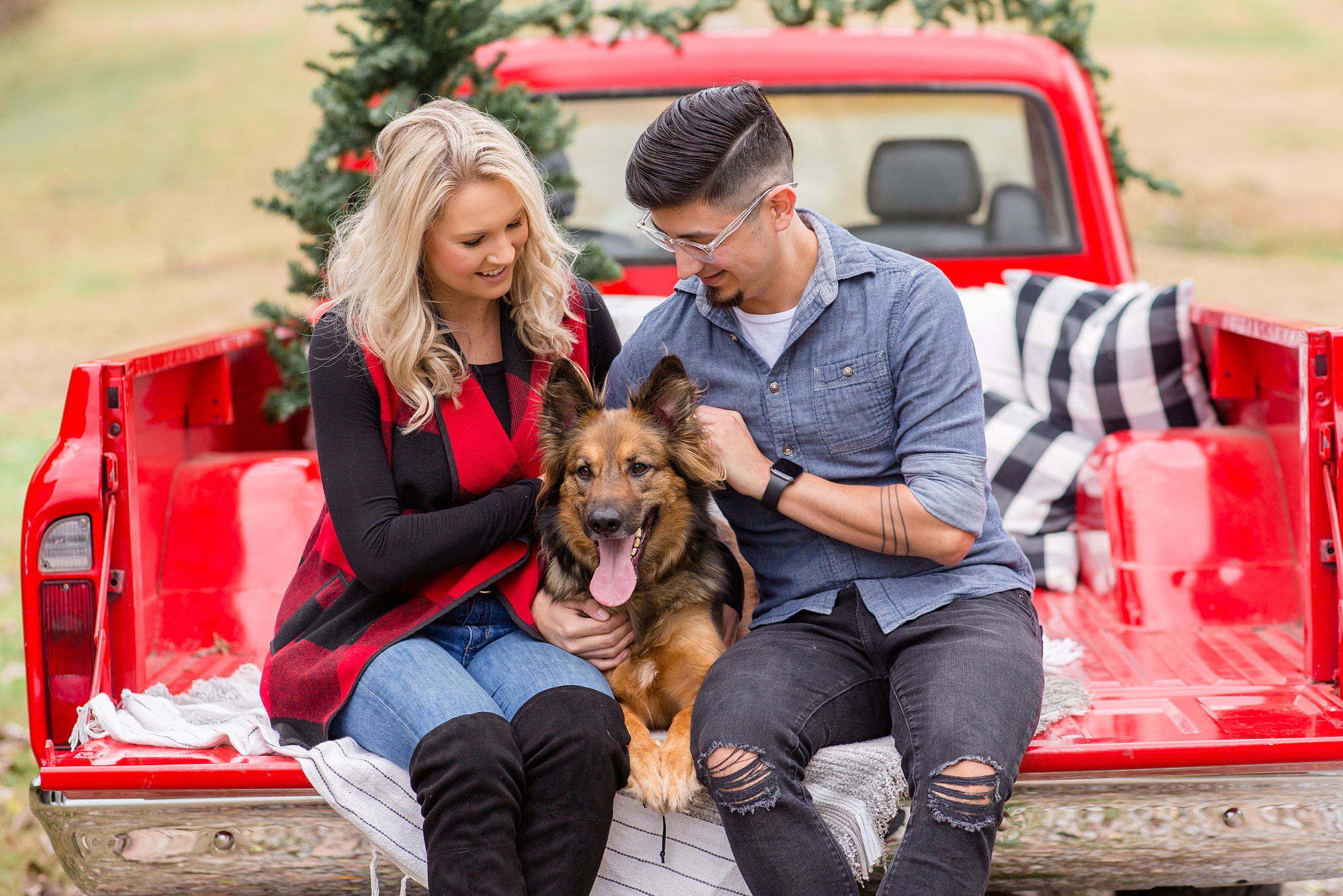 parents pose with dog during Tennessee Red Truck Christmas Minis