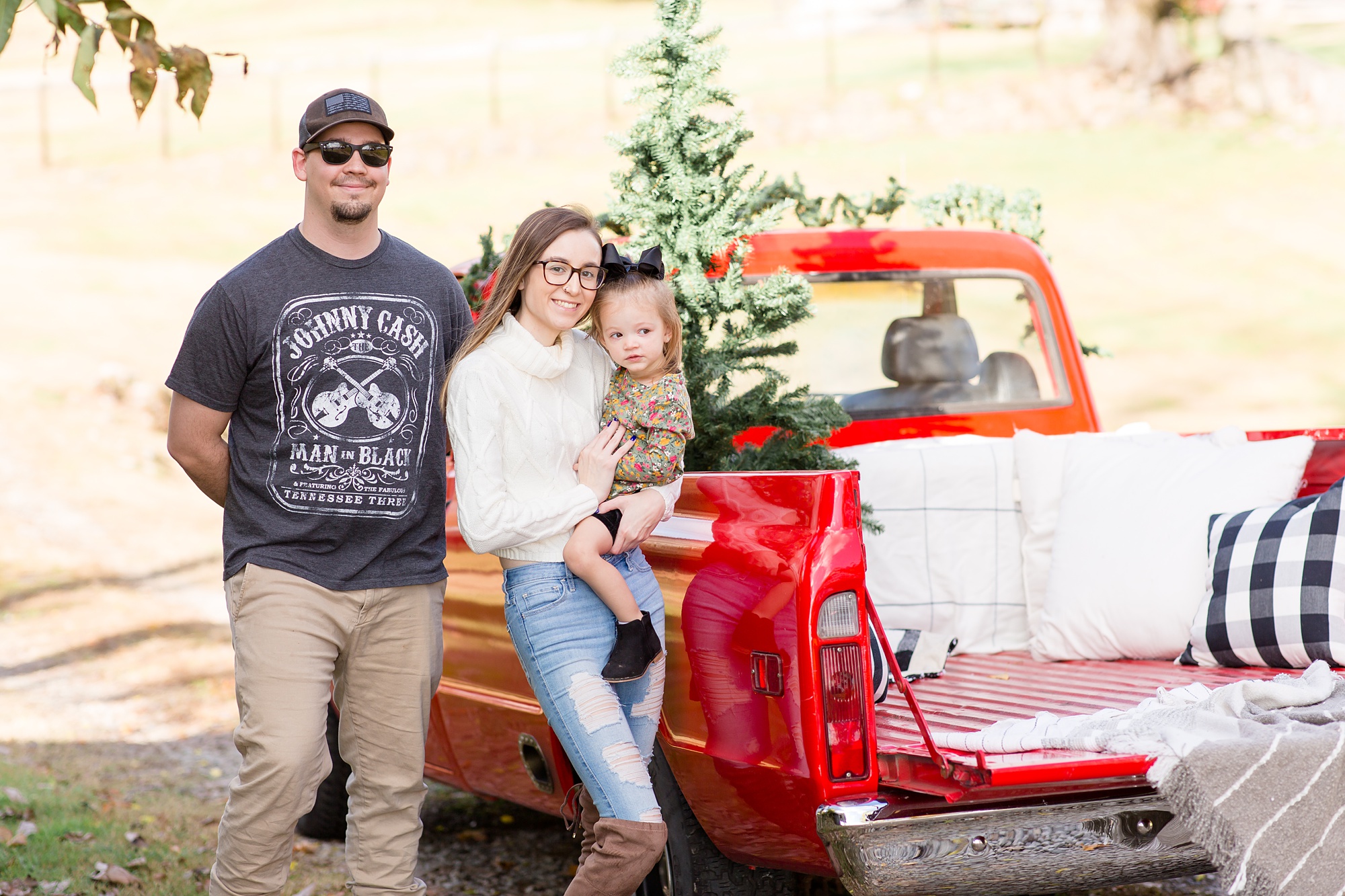 parents pose by truck with daughter