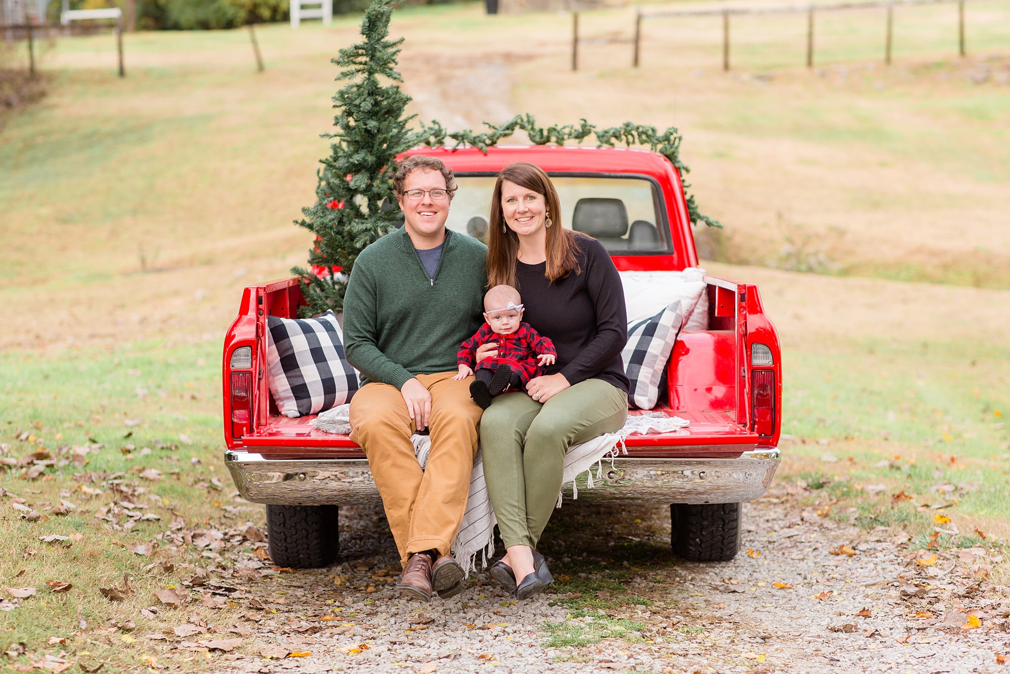 parents sit in truck with little girl during Tennessee Red Truck Christmas Minis