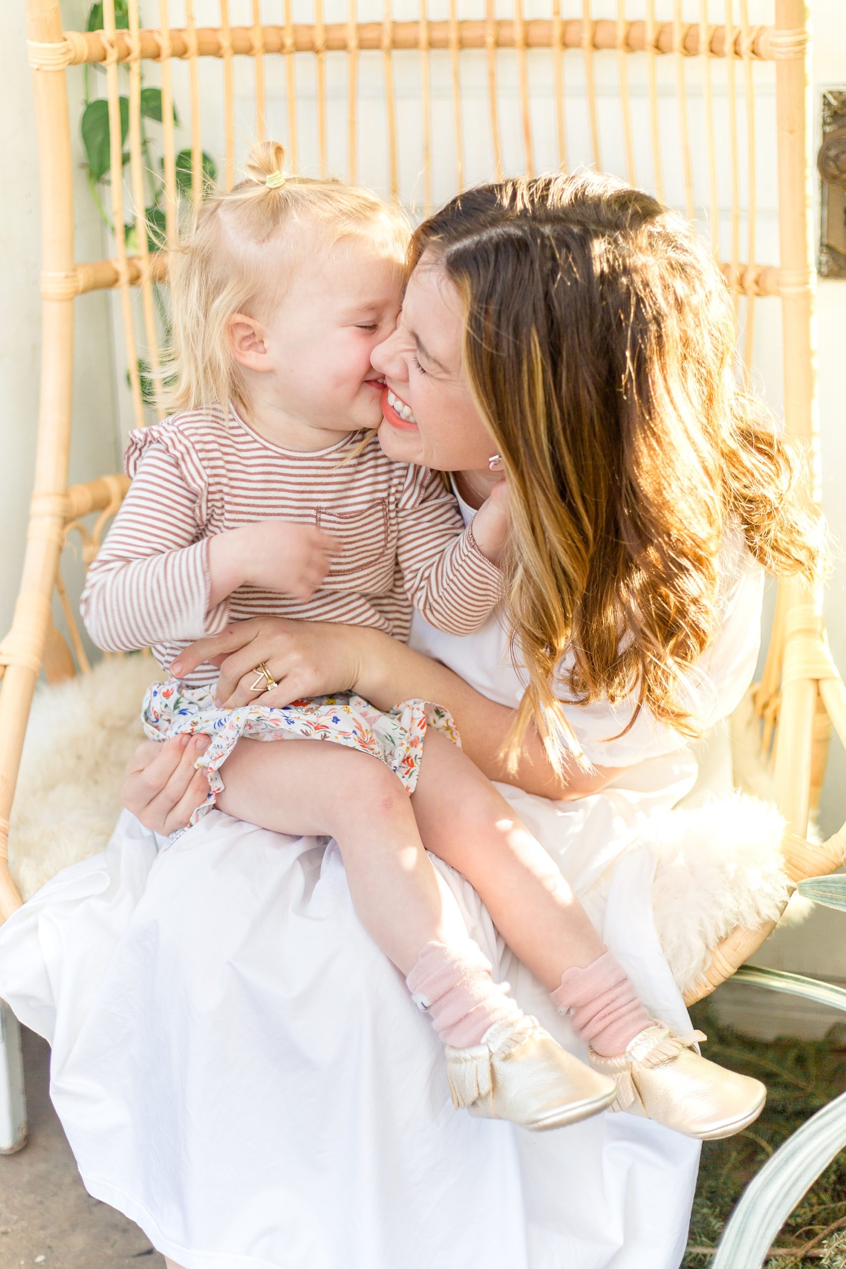 mom and toddler laugh together during mommy and me photos