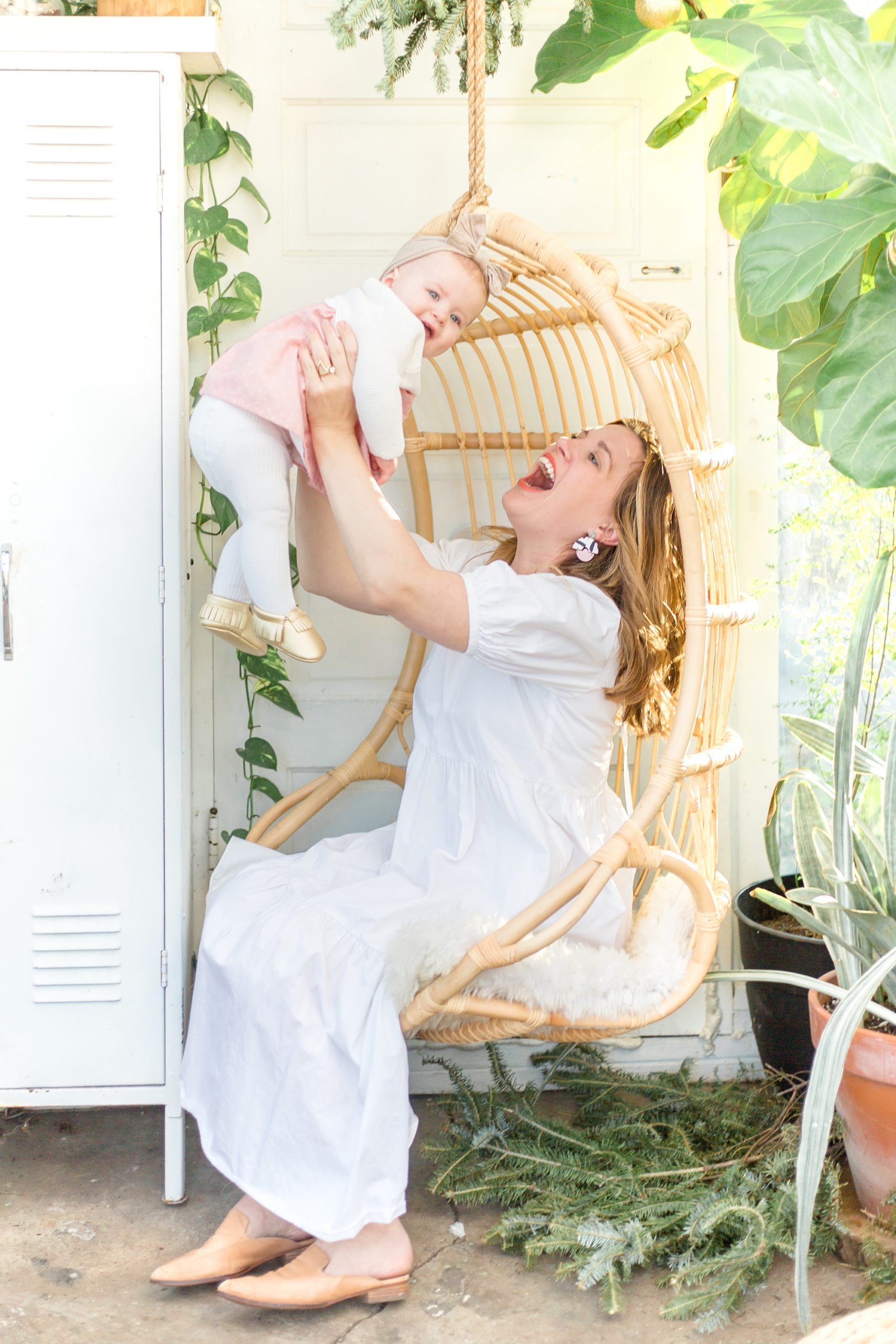 mom and baby laugh together in East Nash Greenhouse