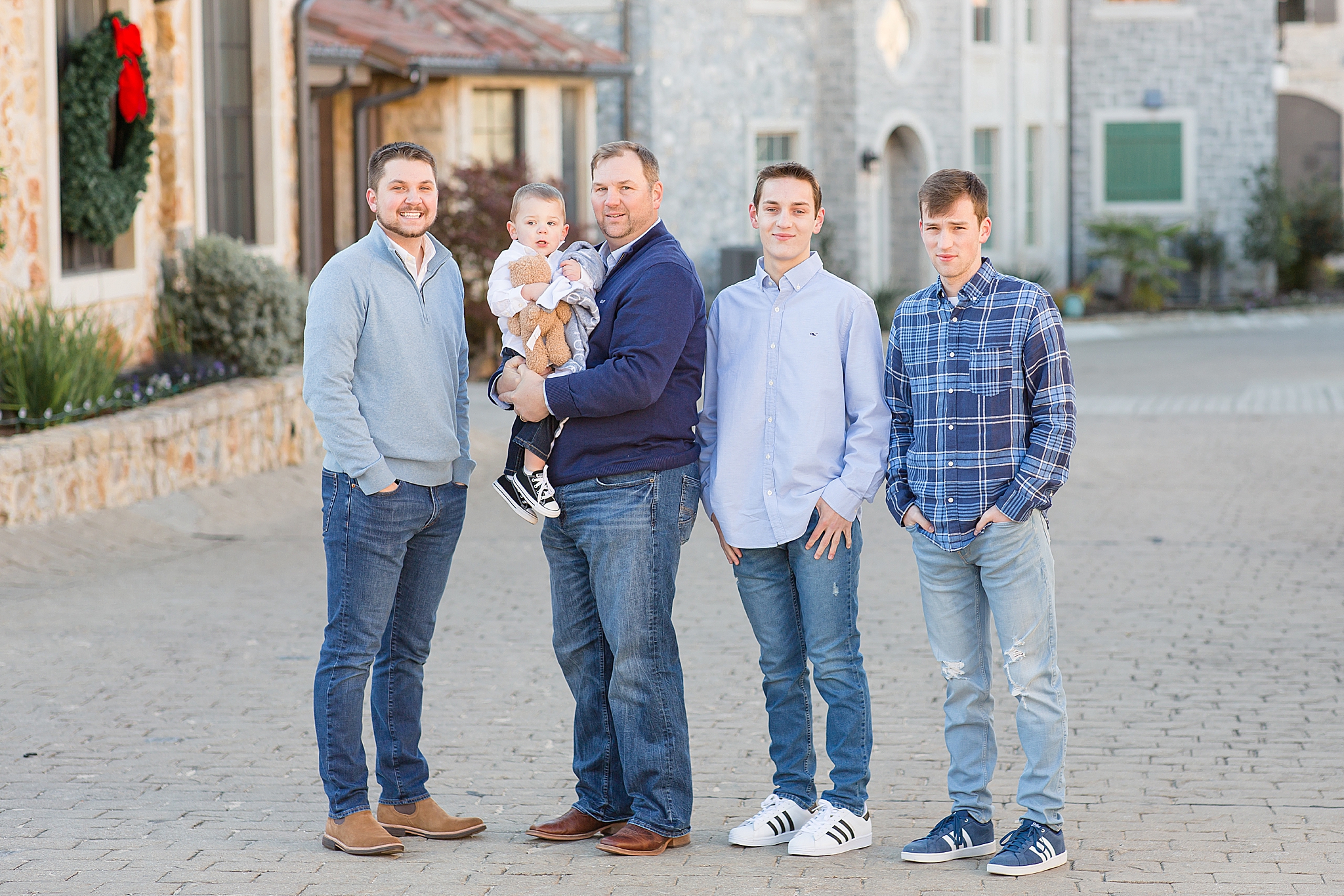 dad poses with sons and grandson during McKinney extended family session
