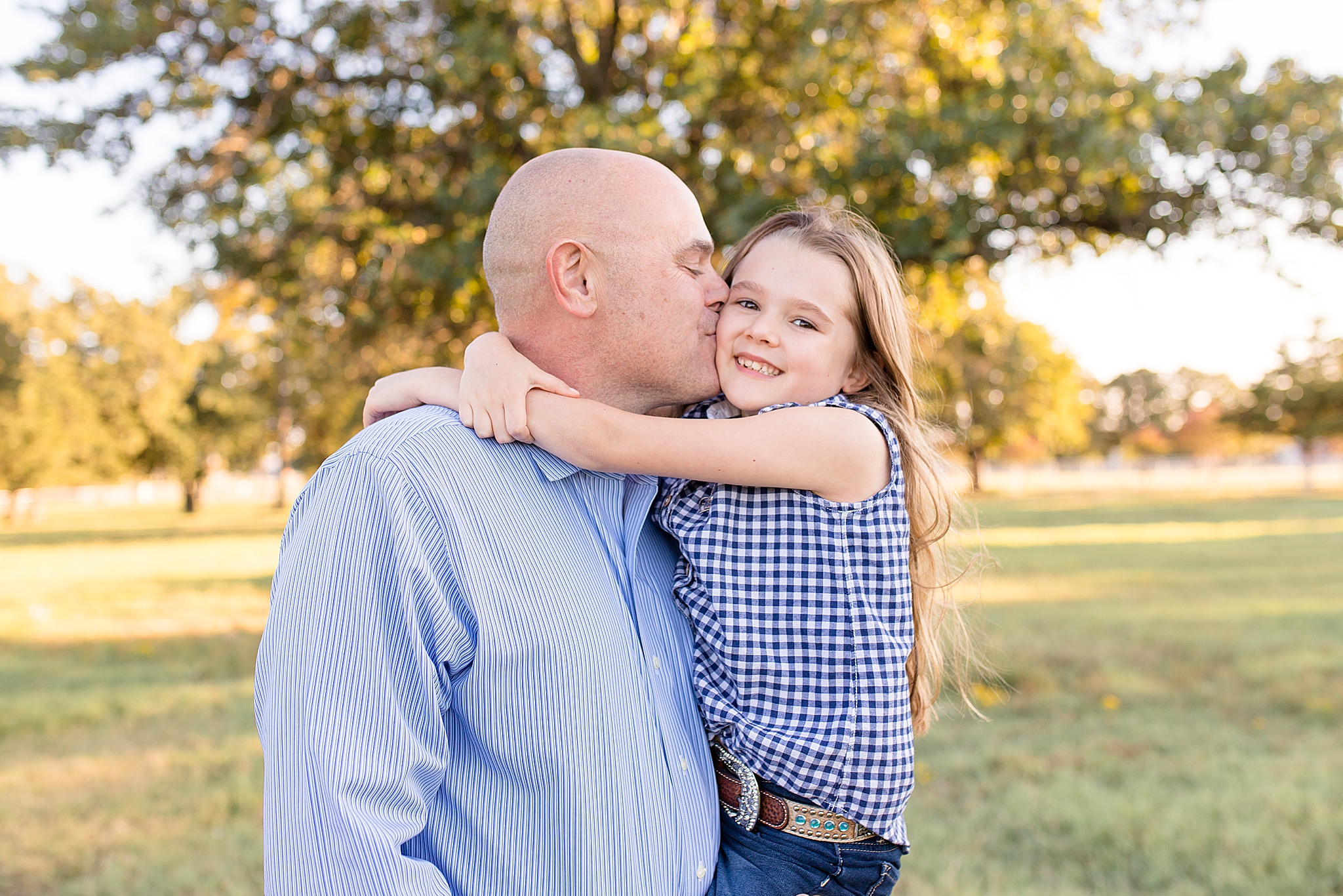 dad kisses daughter's cheek during McKinney family session