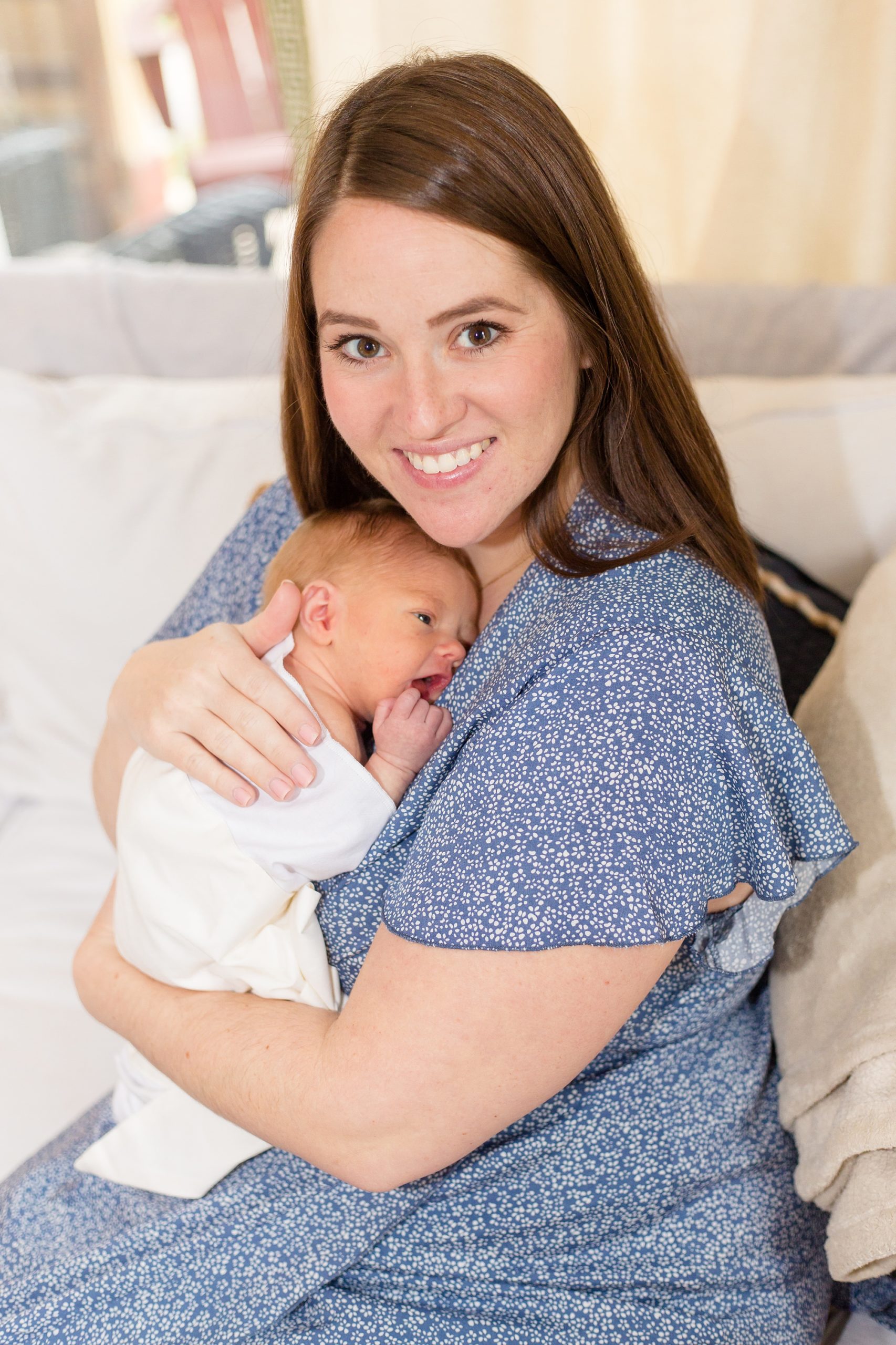 mom holds baby on chest during TN newborn photos