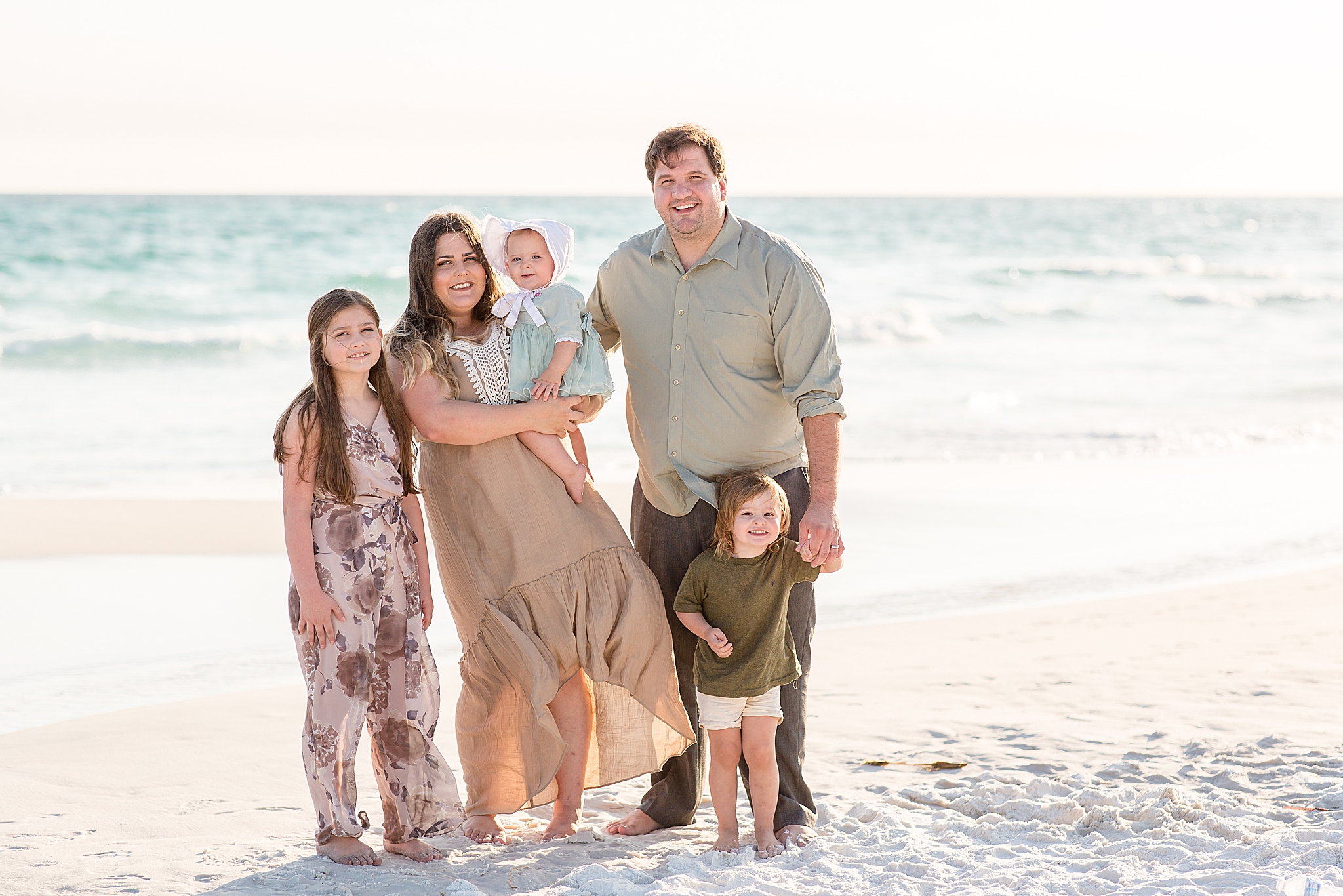 family of five poses by waterfront during 30A Florida Beach Family Portraits