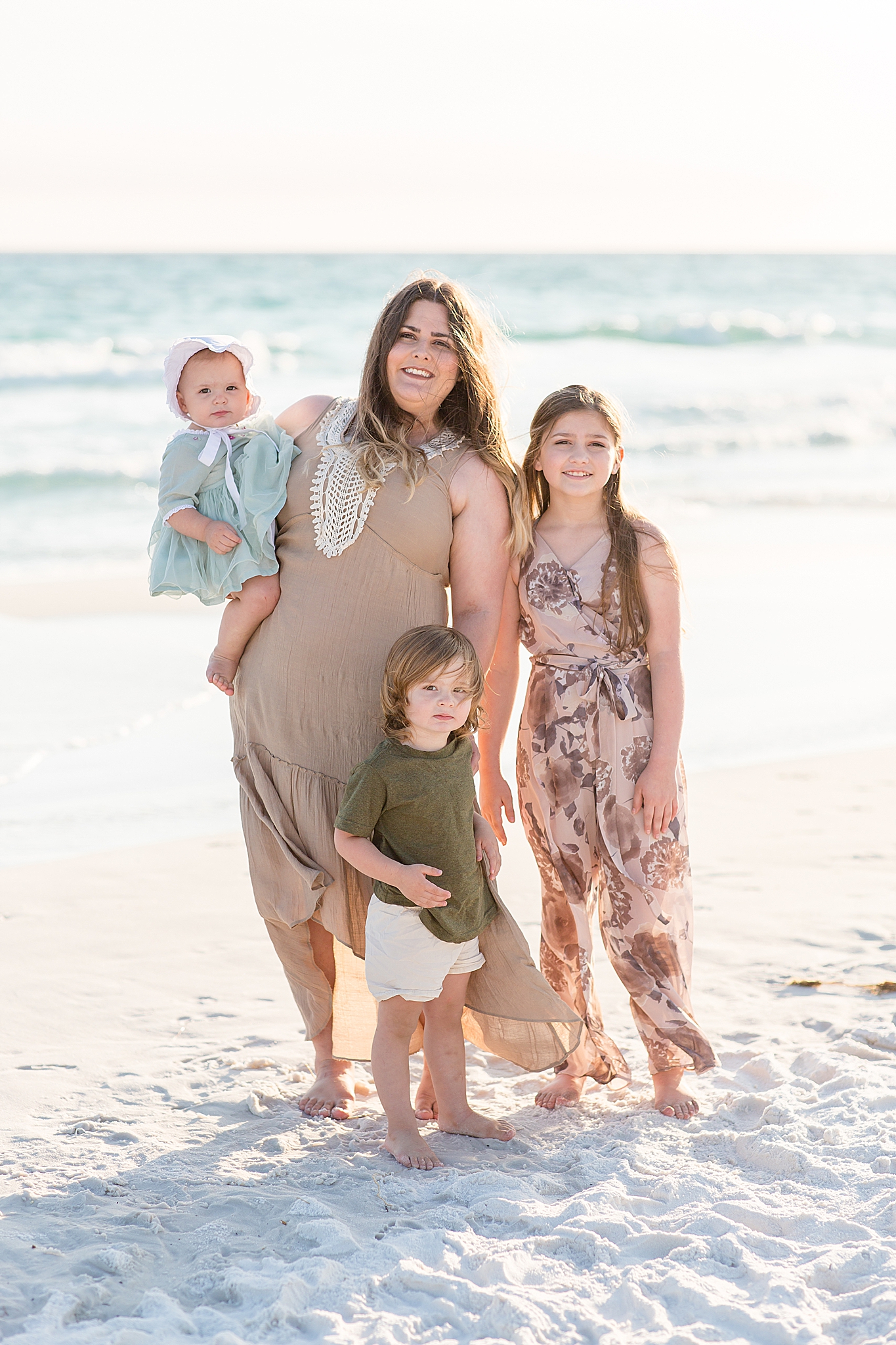 mom and 3 kids pose together on Florida beach