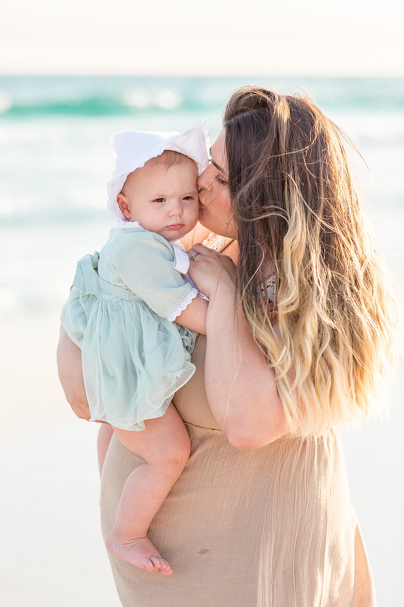mom kisses baby's cheek during 30A Florida Beach Family Portraits