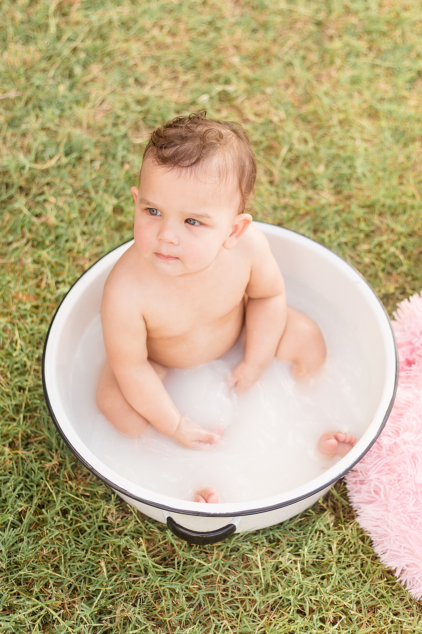 toddler sits in tub after McKinney TX cake smash