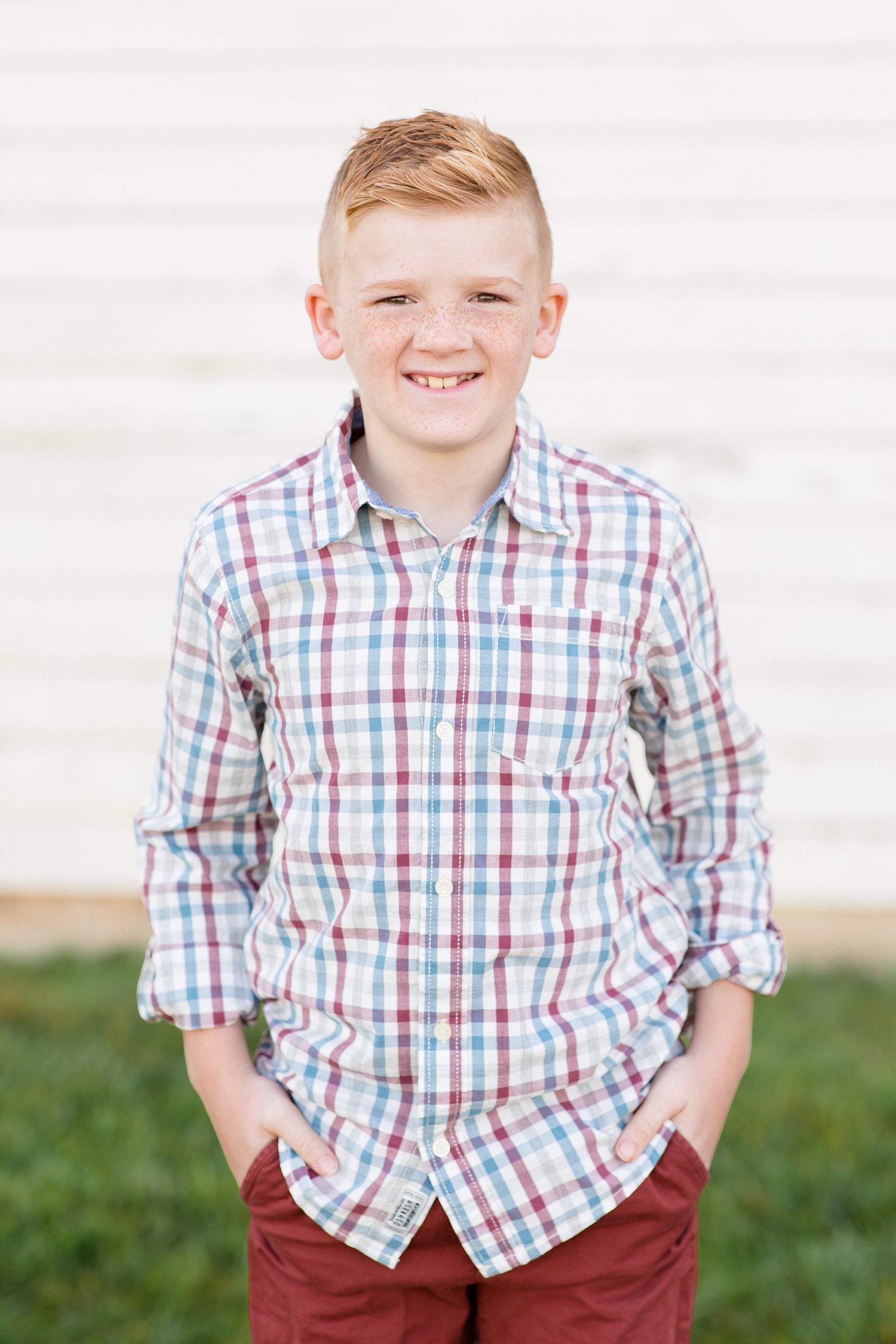 son poses in plaid shirt during TN family photos