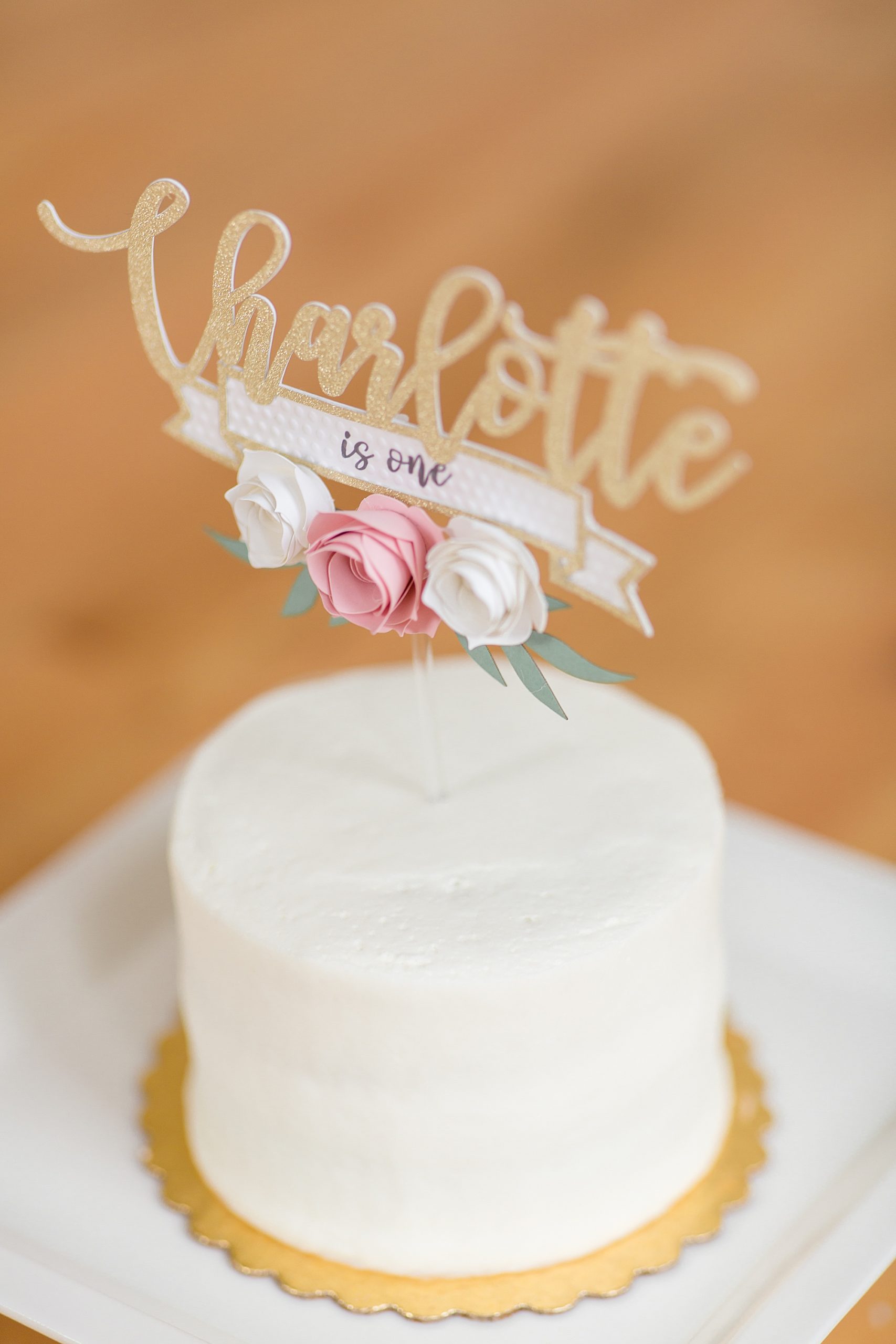 simple white cake with gold topper