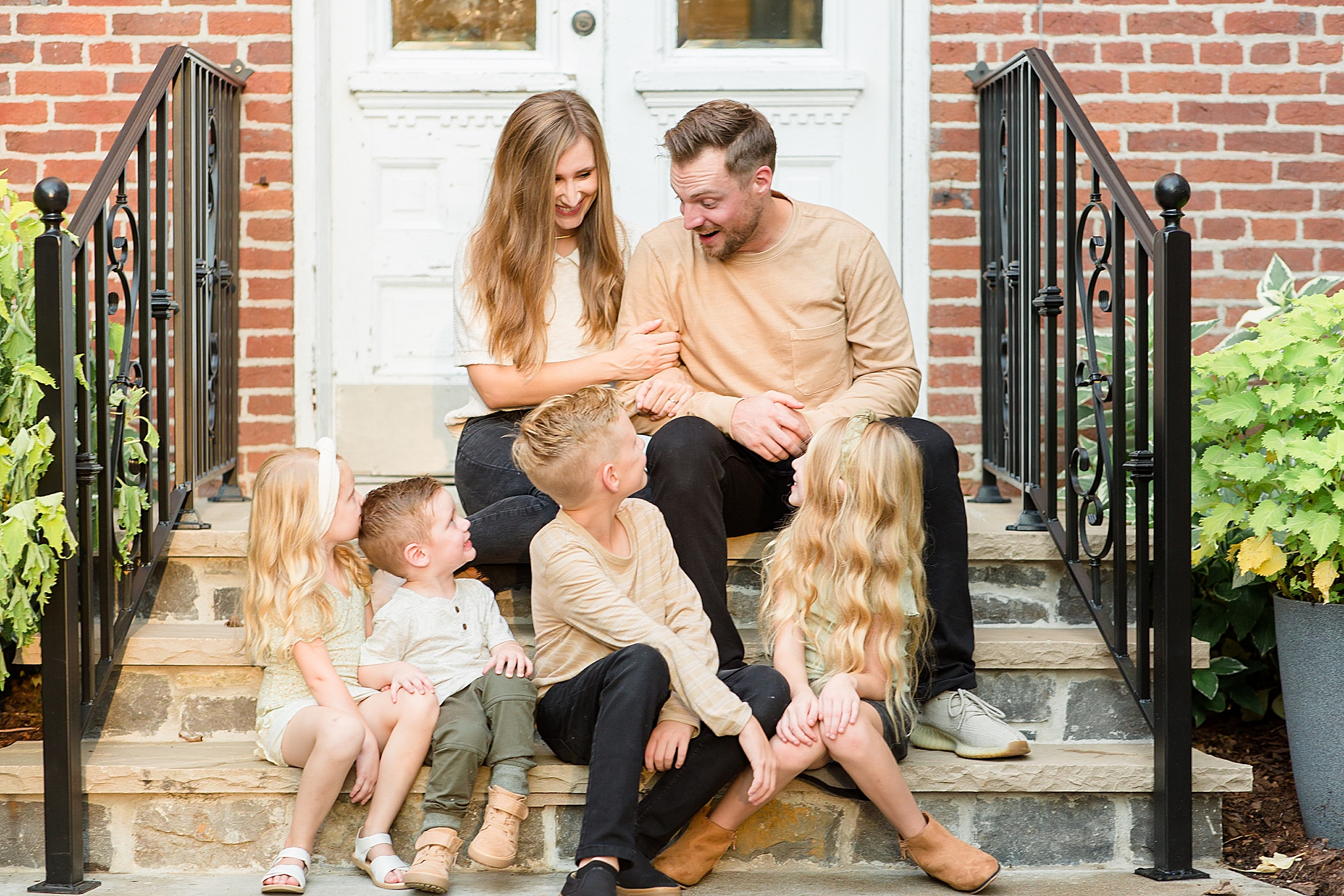 parents look down at four kids during Spring Hill family portraits