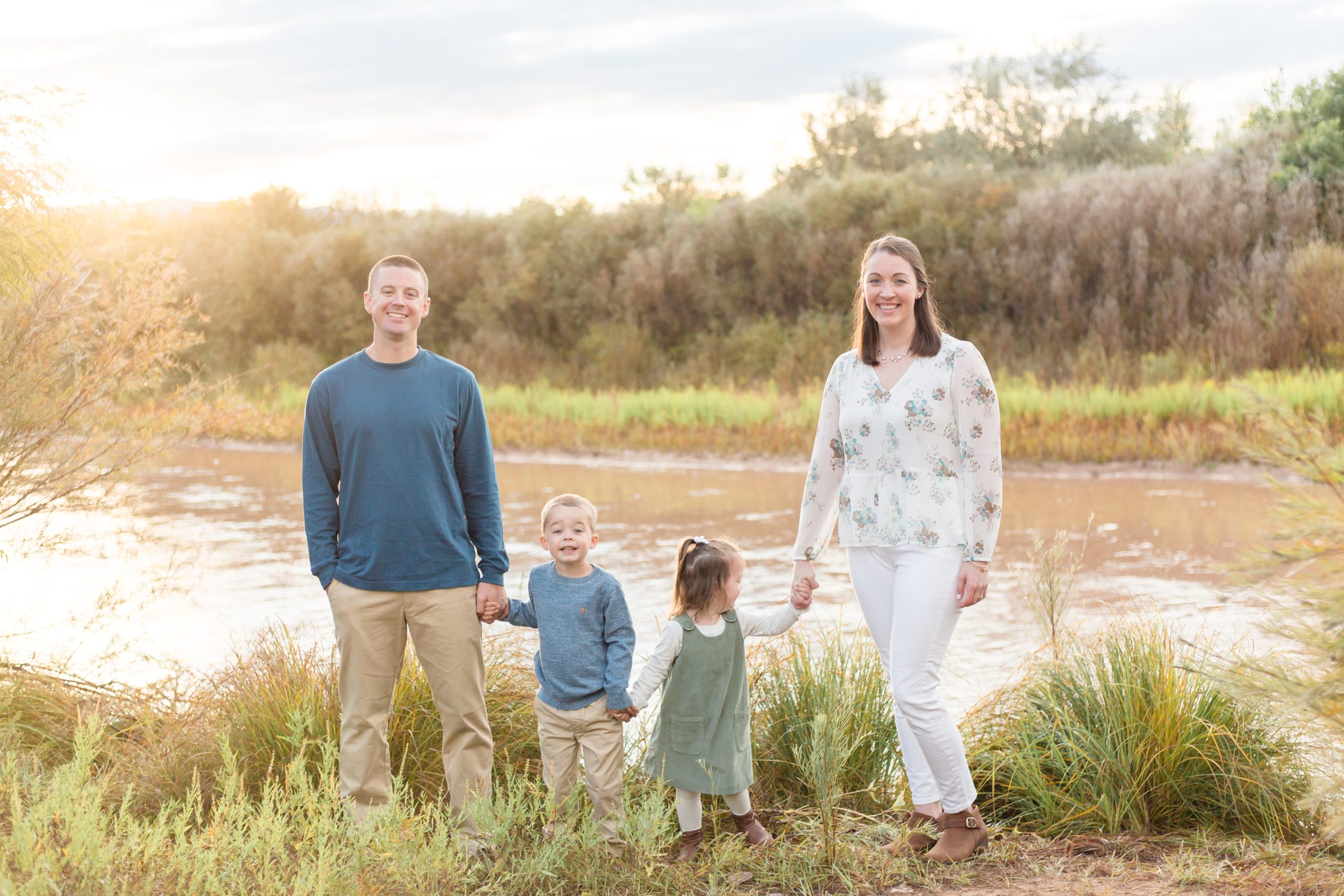family poses in front of river in albuquerque, nm before balloon festival with family photographer Rebecca Rice Photography