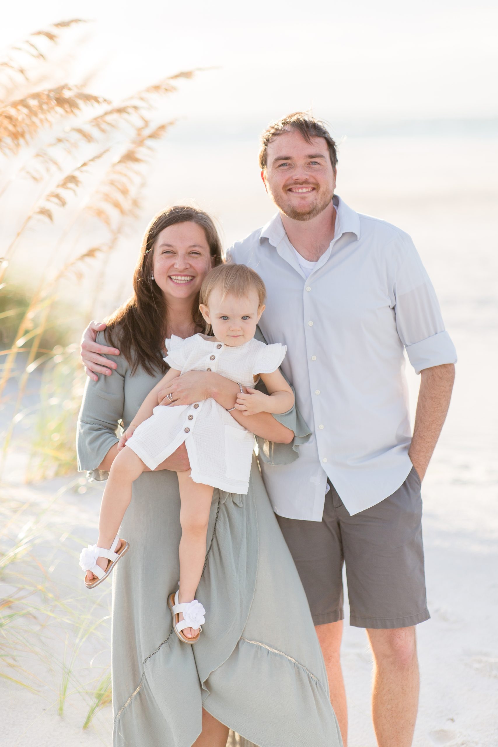 Family of 3 pose during portrait session on Anna Maria Island in Florida with family photographer, Rebecca Rice Photography. Click to see more from this portrait session on the blog now! 