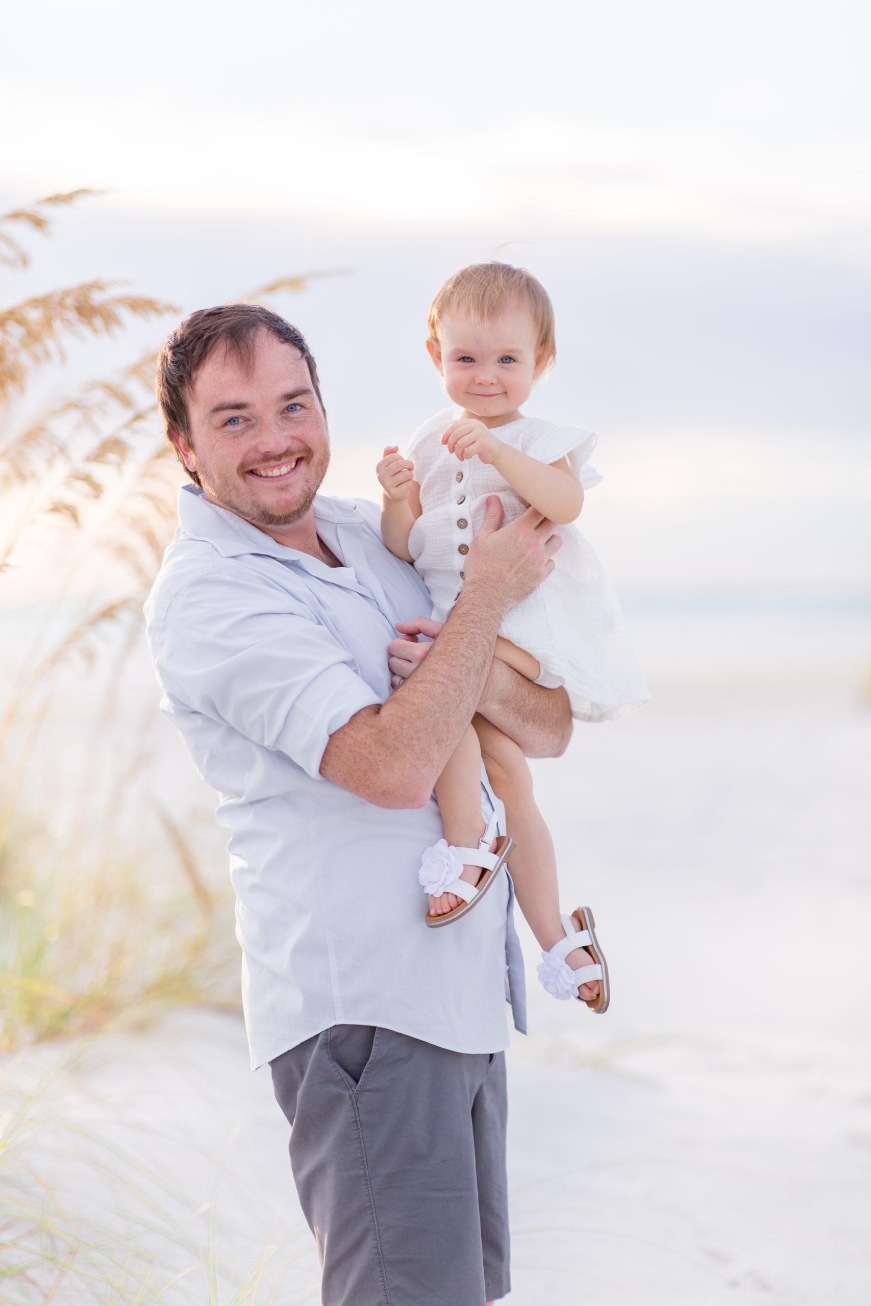 Dad poses with daughter during Anna Maria beach session with family photographer Rebecca Rice Photography. Click to see more from this session on our blog! 