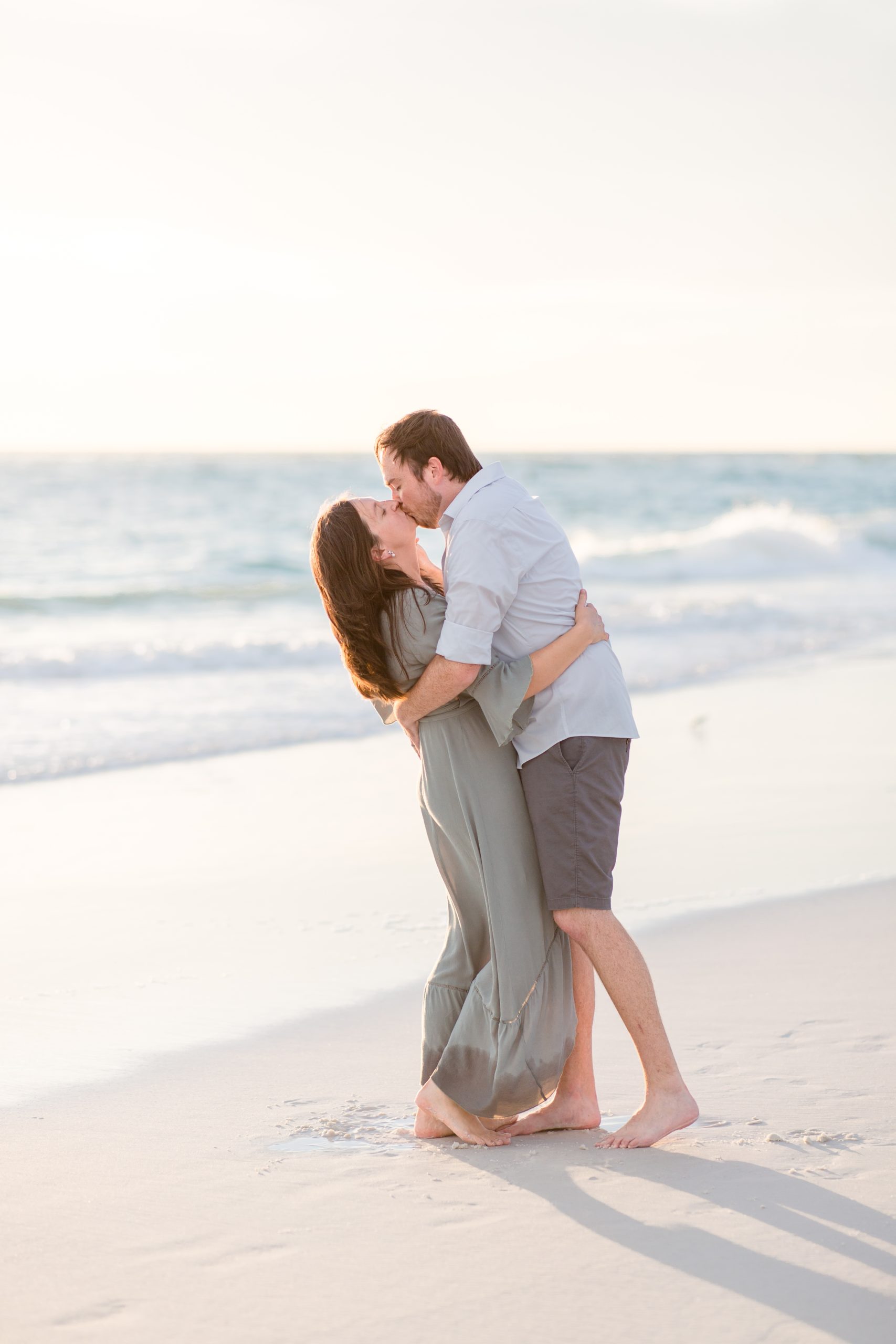husband and wife kiss on beach in Anna Maria Island, FL during family portrait session with Rebecca Rice Photography. Click to see more from this sweet session live on the blog now! 