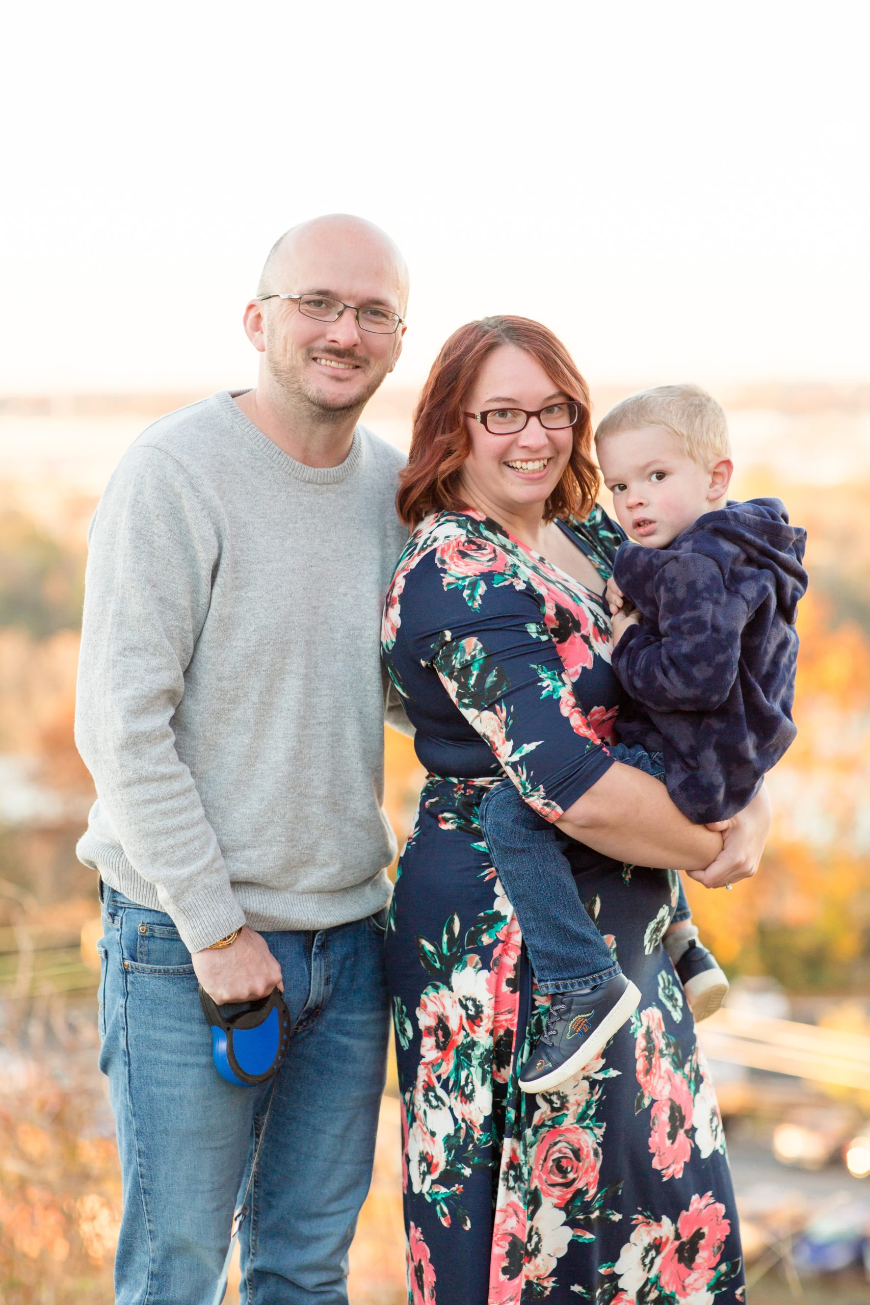 Family of 3 poses during family portrait session at Libby Hill Park in Richmond, VA with family photographer Rebecca Rice Photography. Click to see more from this sweet family session on the blog! 
