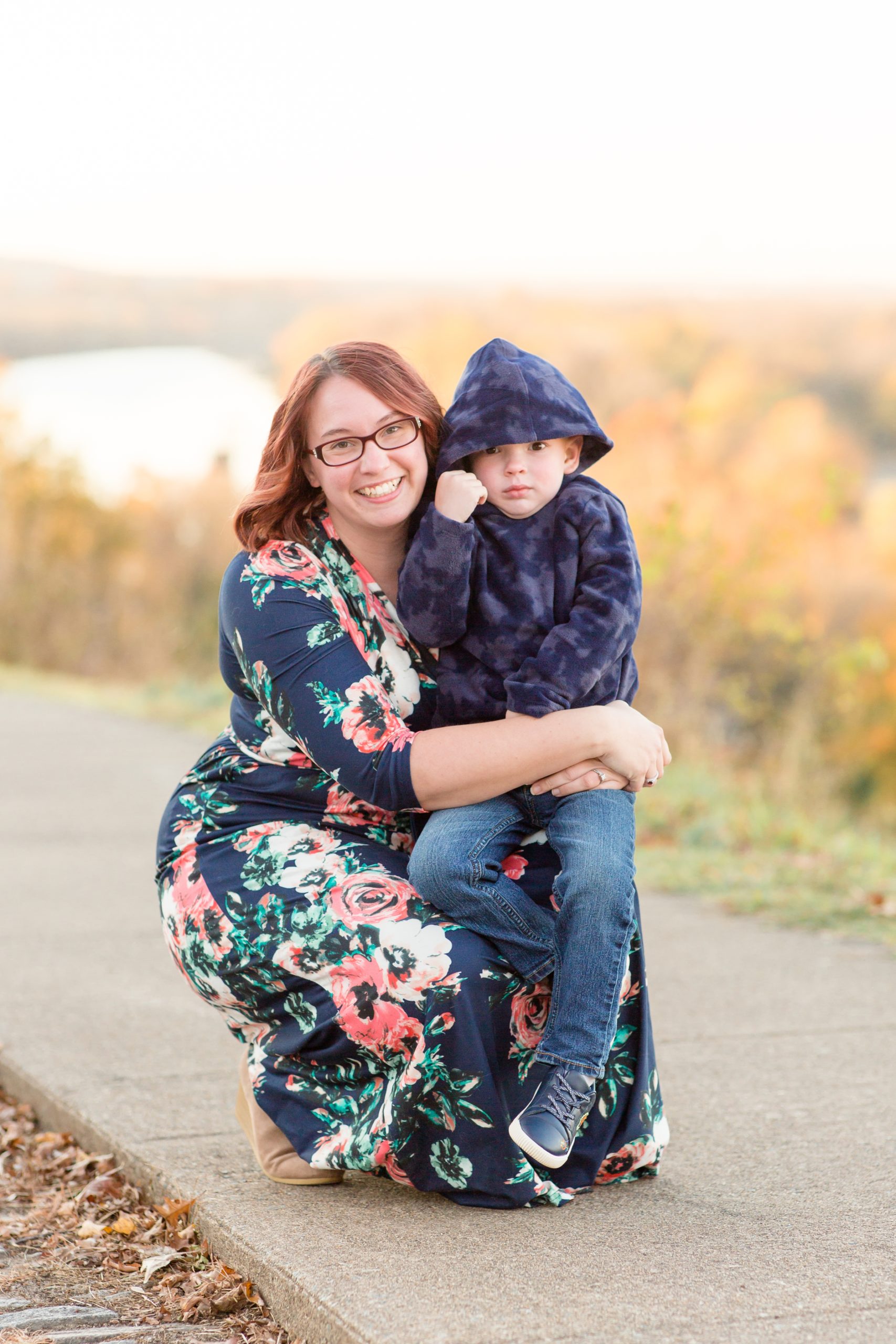 Mother in floral dress and son in blue jacket pose together at Libby Hill Park in Richmond, VA with Rebecca Rice of Rebecca Rice Photography. Click to read more about this sweet session on our blog! 