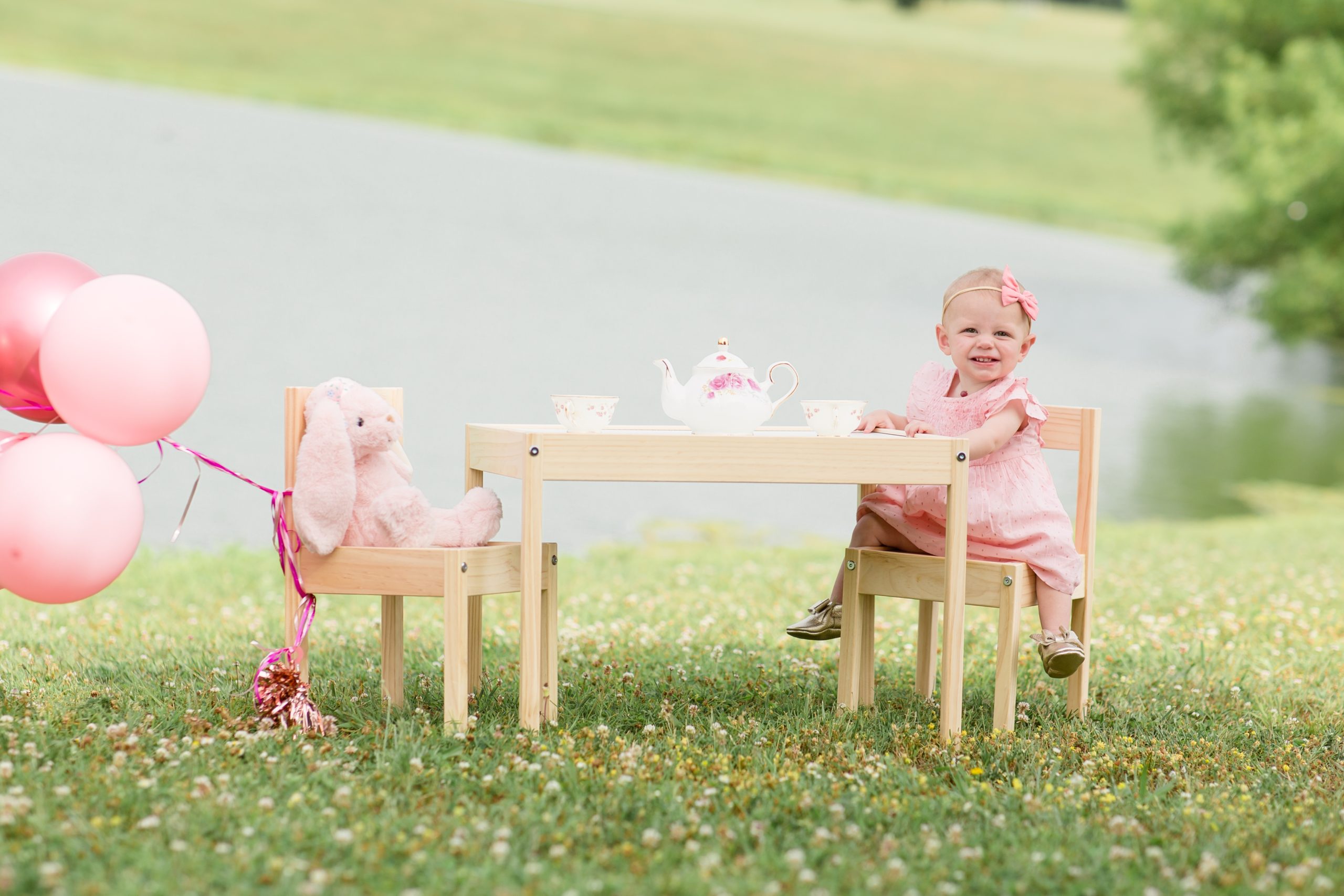 One year old sits at a tea party set up for first birthday smash cake session at Harlinsdale Farm in Franklin, TN with family photographer and educator Rebecca Rice of Rebecca Rice Photography. Click to see more from this sweet session on the blog now!