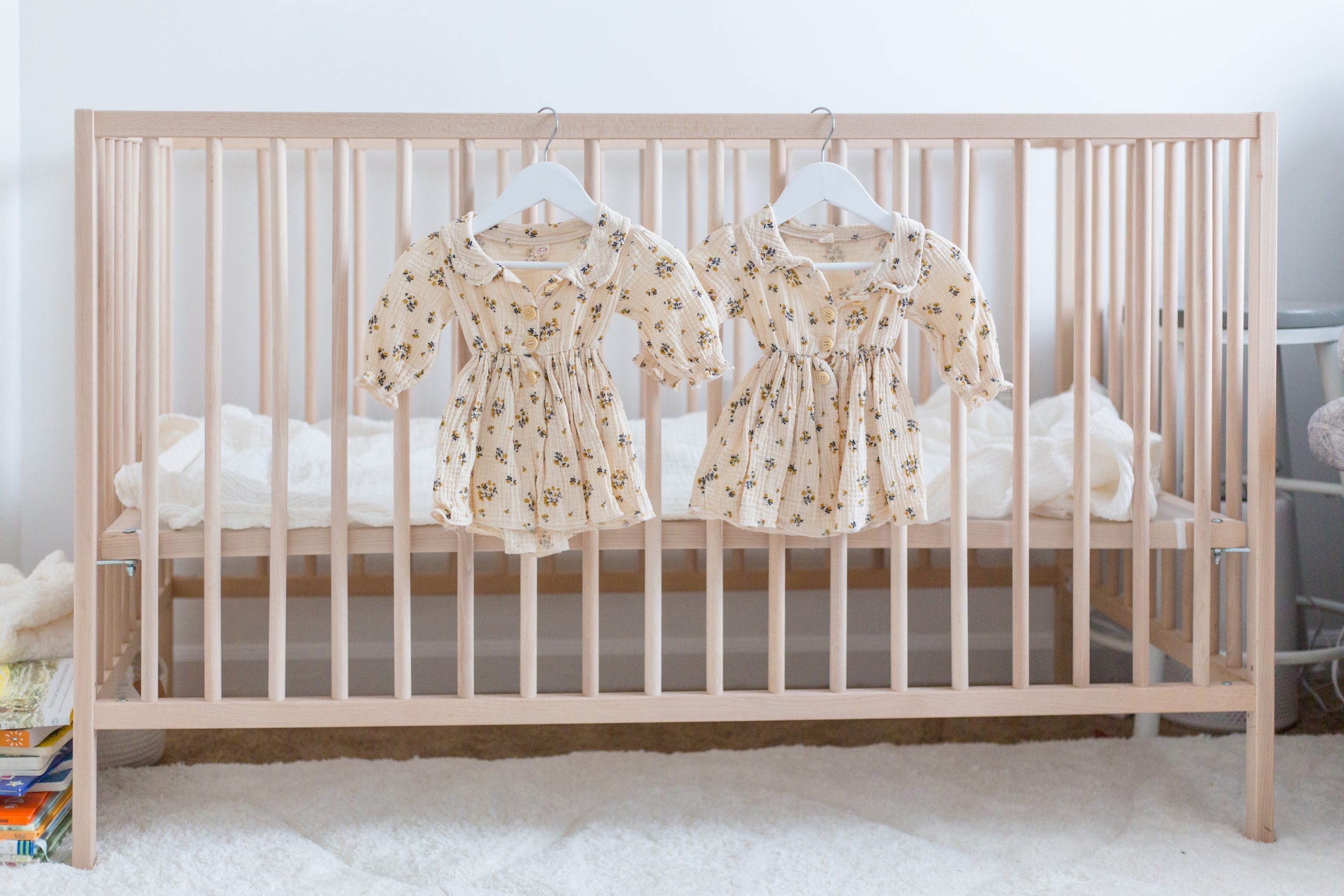 Detail photos are so important! This sweet family was expecting twins so we hung 2 matching outfits on the babies' crib. How adorable is this? Click to see more from this sweet session live on the blog now. 
