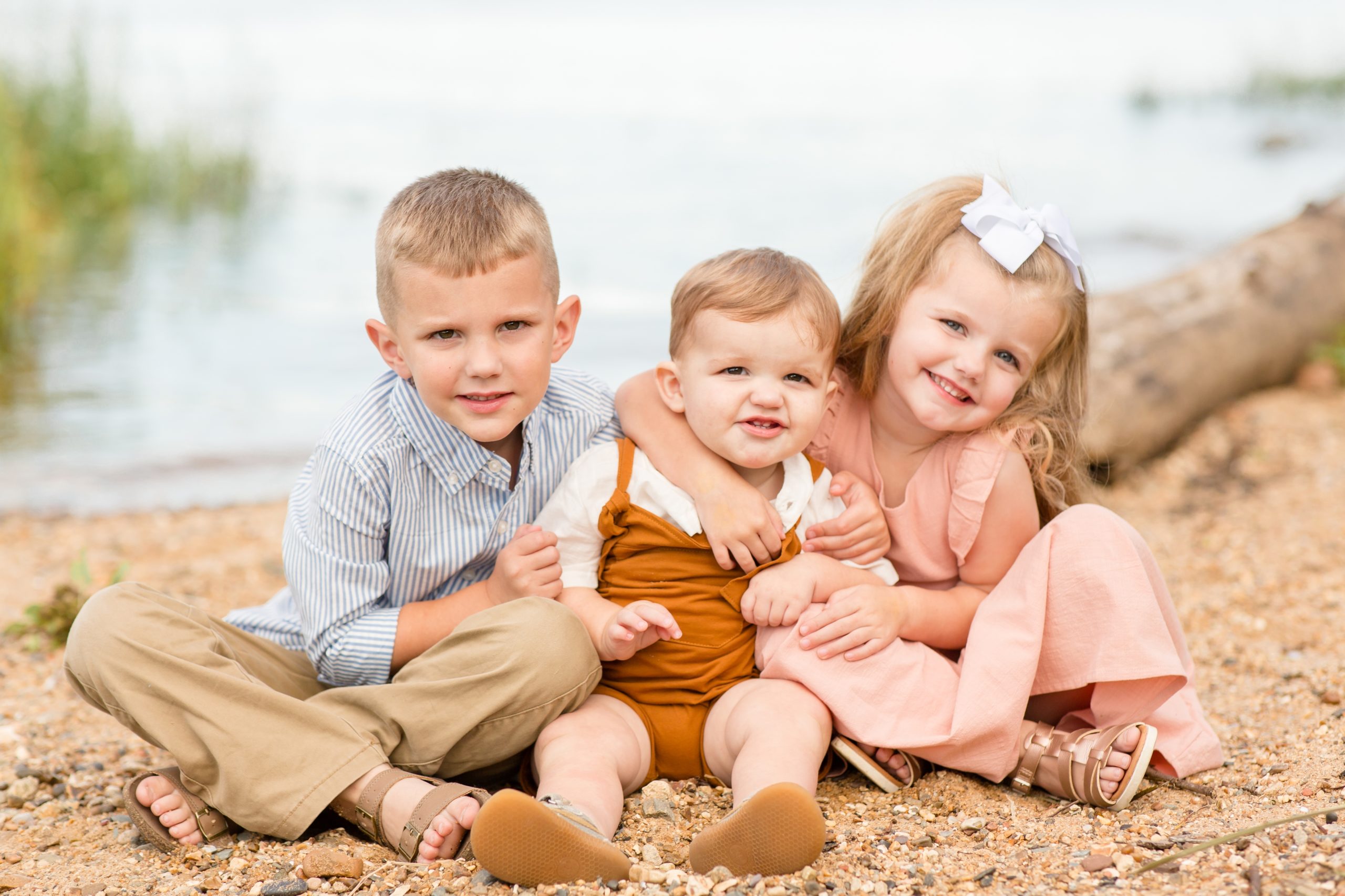 Siblings sit together next to James River during family portrait session with family photographer Rebecca Rice Photographer. Click to see more from this sweet session live on the blog now! 