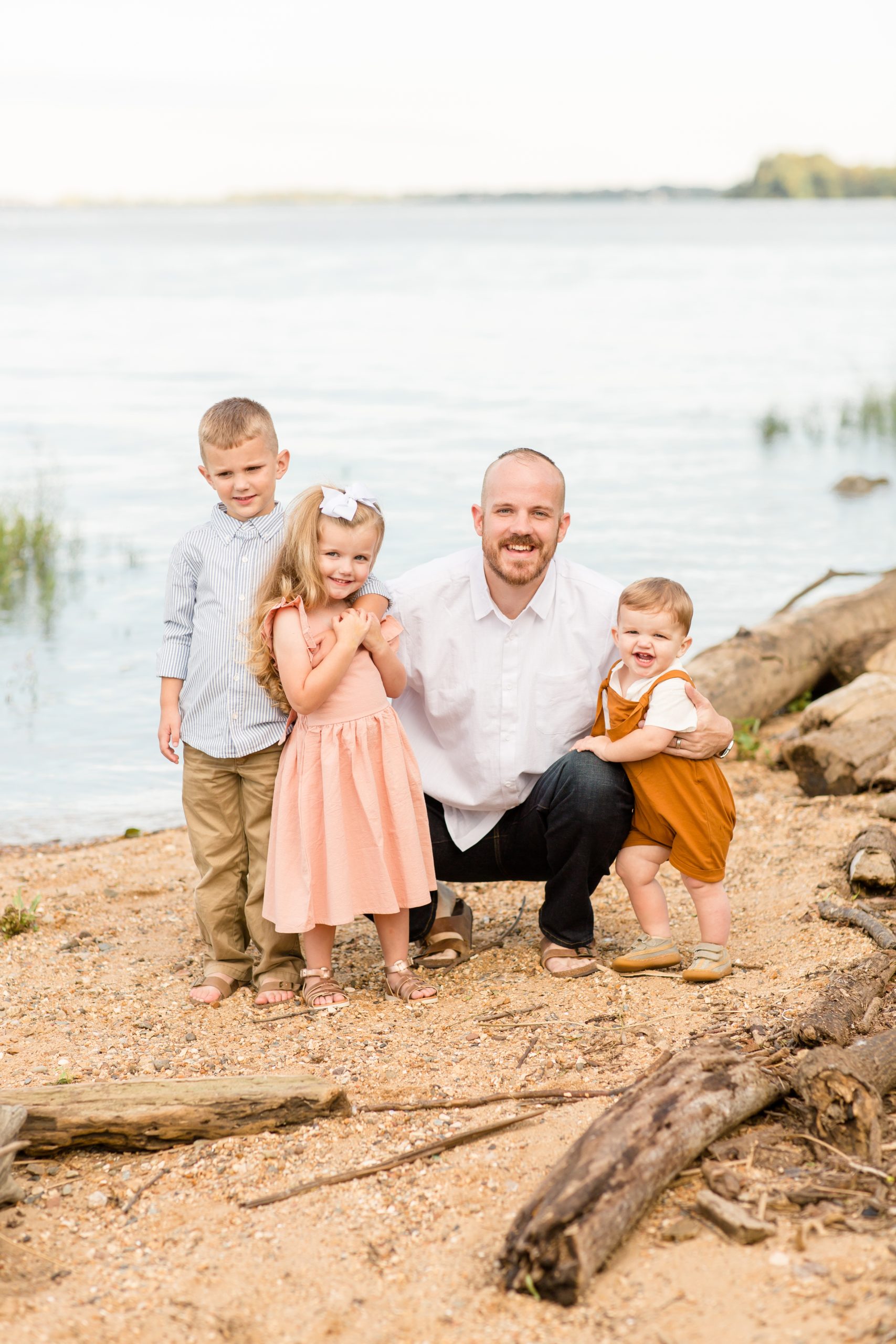 Siblings stand together next to dad by James River during family portrait session with family photographer Rebecca Rice Photographer. Click to see more from this sweet session live on the blog now! 