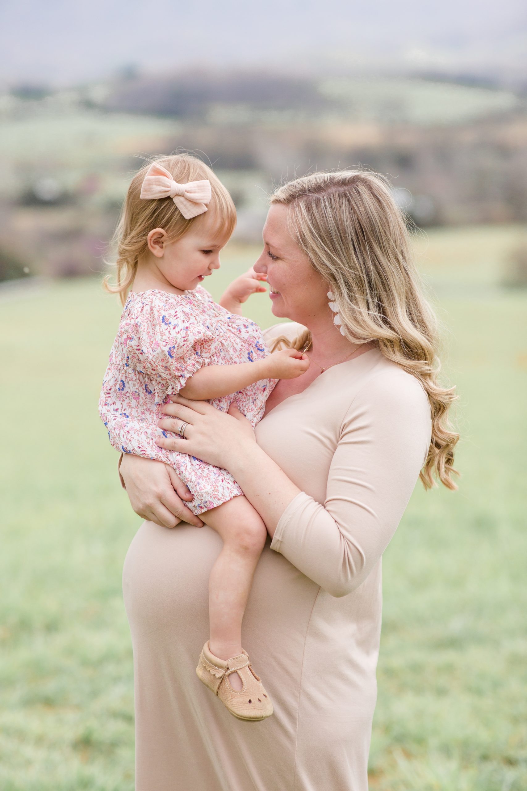 Pregnant mom holds daughter during maternity session in Lexington, VA with family photographer Rebecca Rice Photography. This sweet session was featured on Behind the Lens! Go with me to the session and see how I shot this session! 