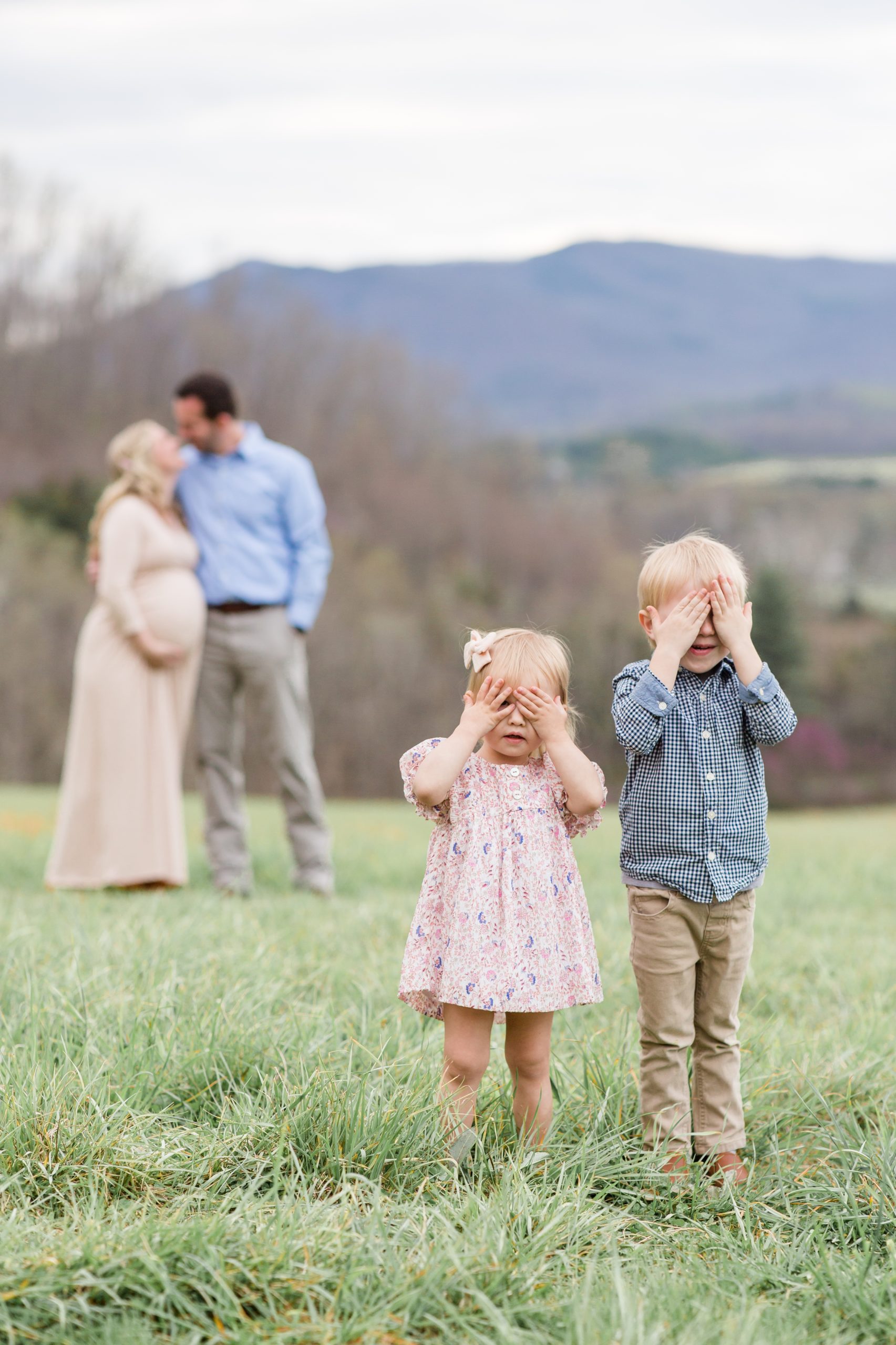 Kids pose in front of parents during maternity session in Lexington, VA on a mountainside with family photographer Rebecca Rice Photography. Click to read more about this precious session live on the blog now! 