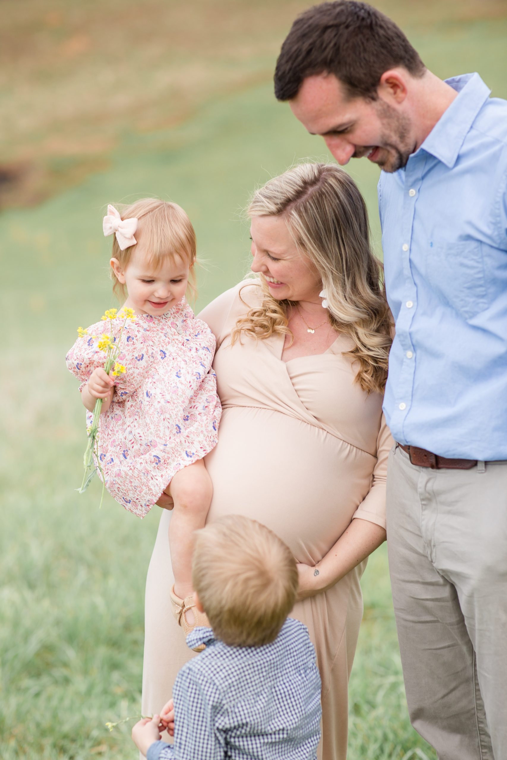 Family poses together during family maternity session mountainside in Lexington, VA with family photographer and educator Rebecca Rice of Rebecca Rice Photography. Click to see more from this sweet session live on the blog now! 