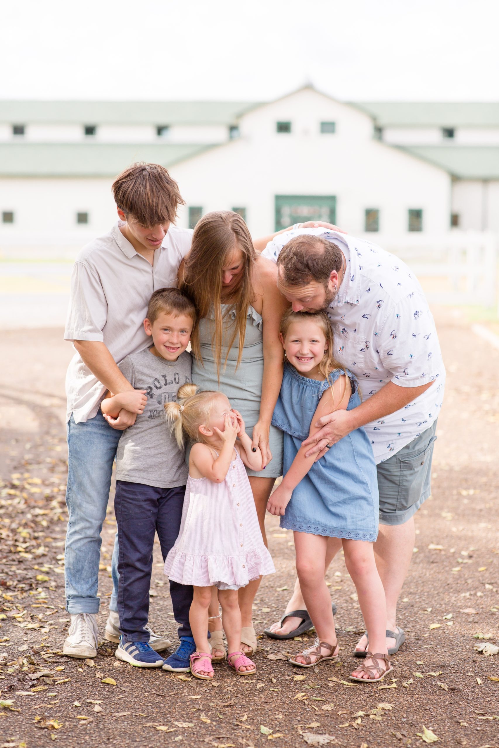 Parents tickle kids during mini session in Franklin, TN at Harlinsdale Farm in the fall with family photographer and educator Rebecca Rice of Rebecca Rice Photography