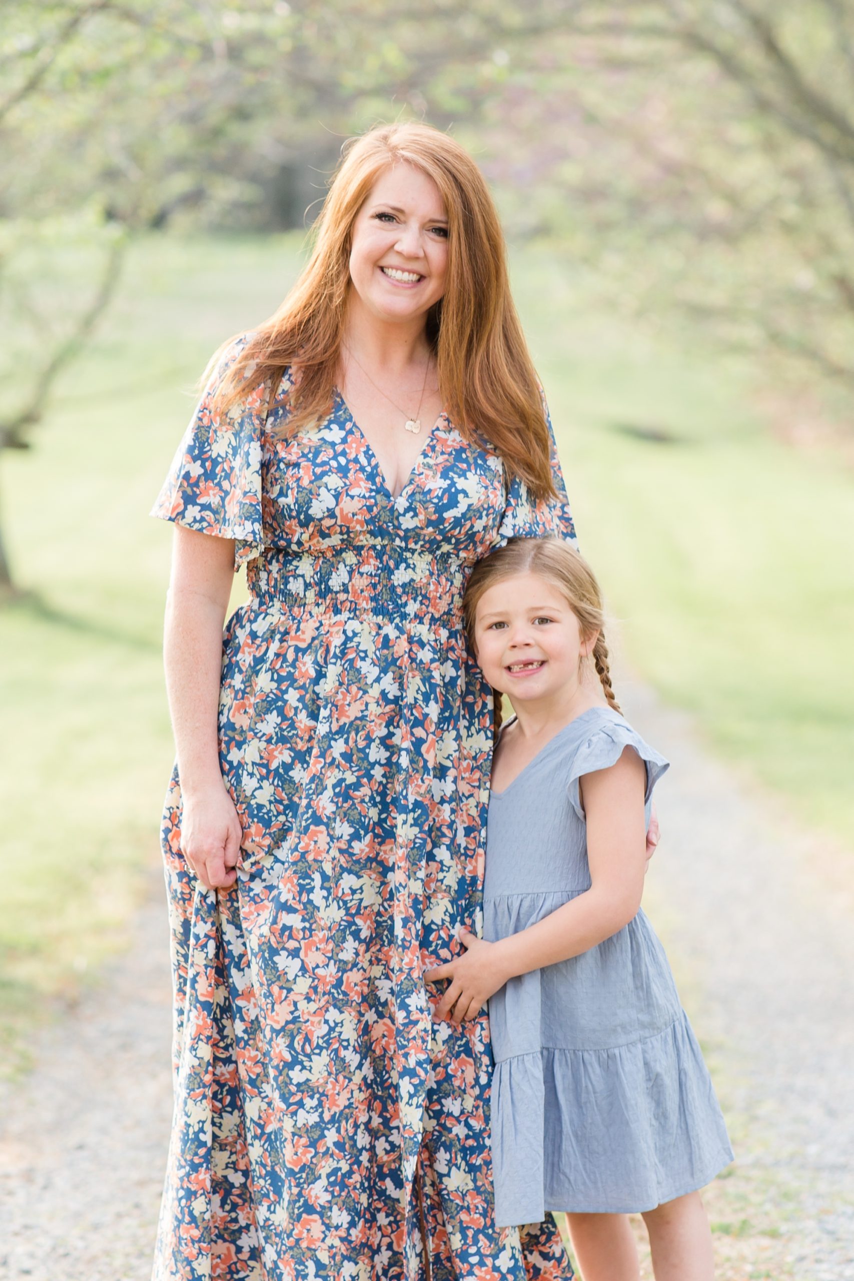 Mom in blue floral dress poses with daughter in chambray dress during spring portrait session with Rebecca Rice of Rebecca Rice Photography. Click to see more from this stunning session live on the blog now. 
