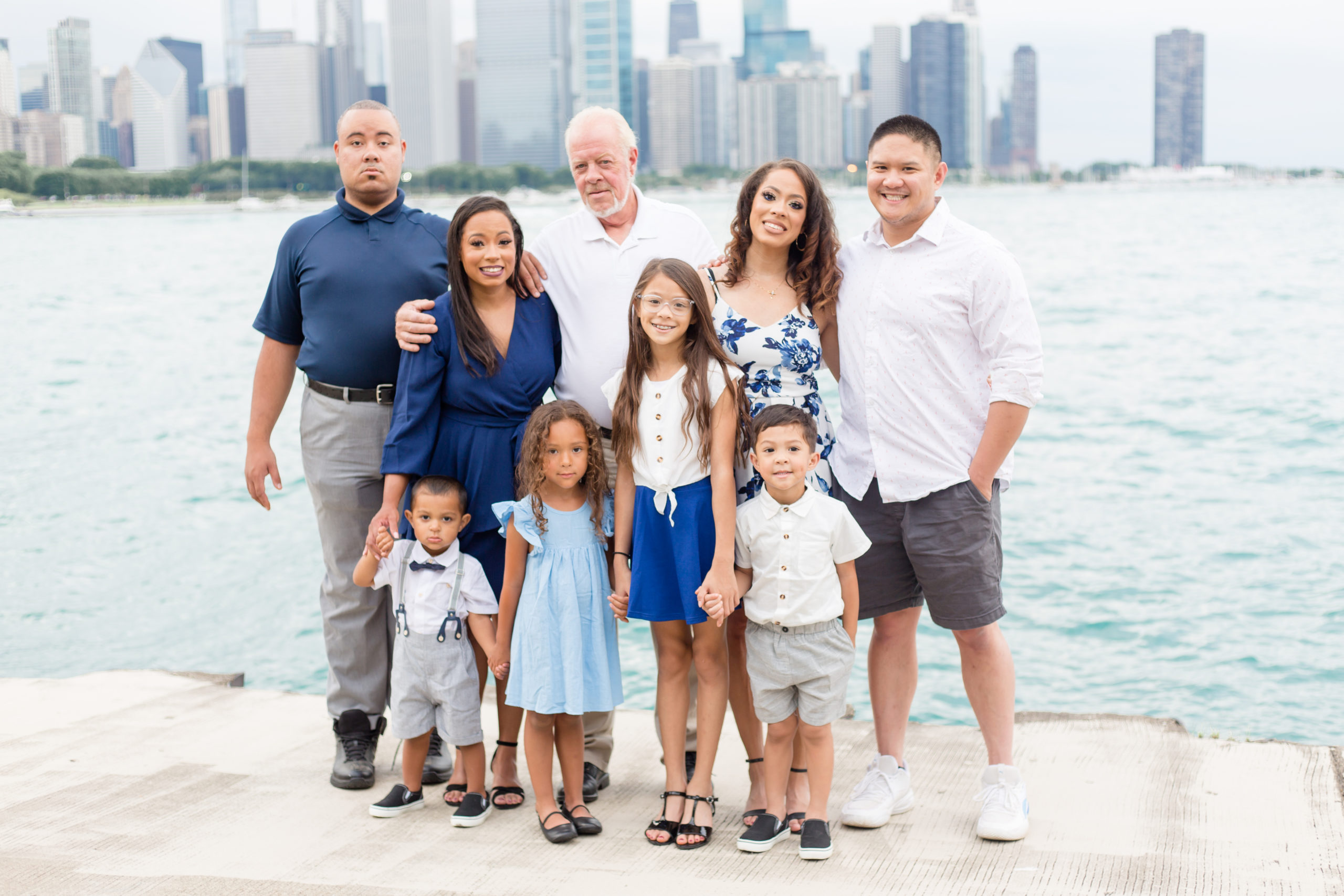 Check out the blog for this Extended Family Session in Downtown Chicago. Beautiful family of 9 standing with downtown Chicago in the background. This family is dressed in a variety of shades of blue and white. 