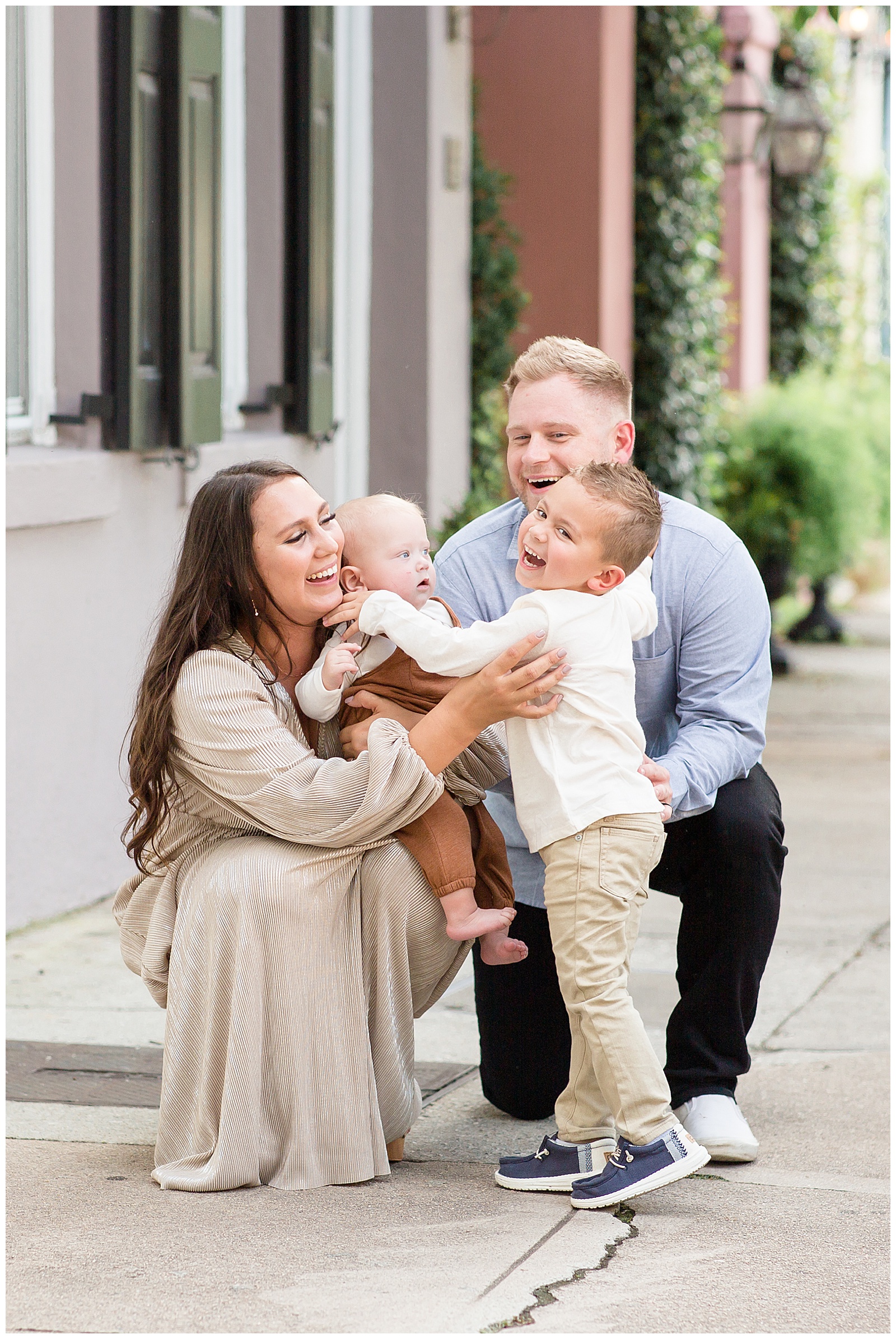 Family of four with a baby boy and little boy have a family session with Charleston family photographer, Rebecca Rice at Rainbow Row and the Isle of Palms beach.