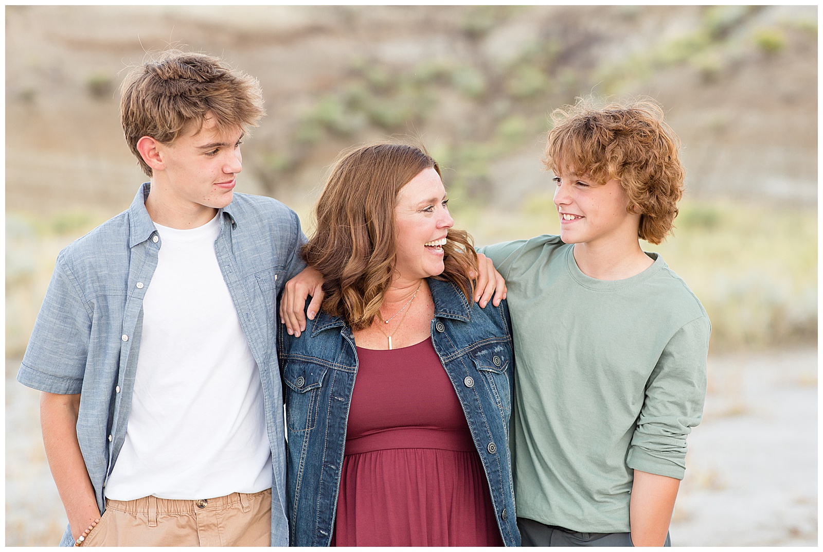 Mom of teen boys laughs with sons during family photography session with Rebecca Rice Photography in North Dakota.
