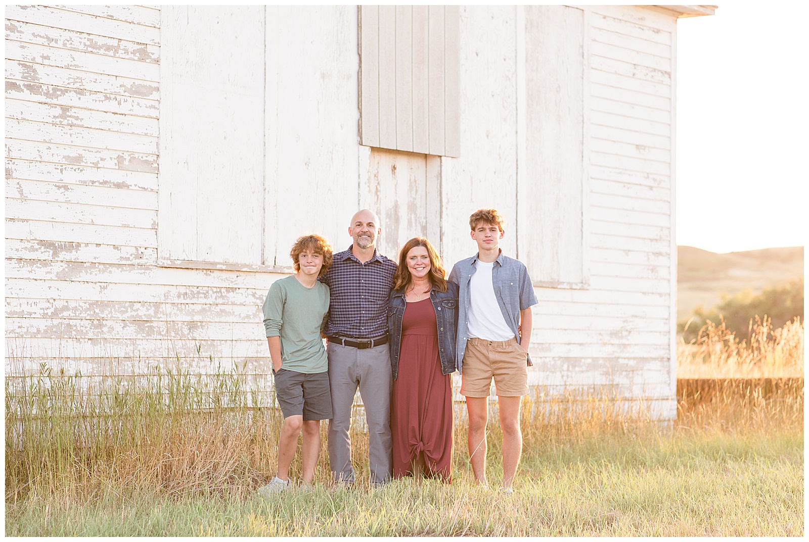 Family of 4, mom, dad, teen boys, smile for family photographer, Rebecca Rice Photography, for their family photography session in North Dakota.