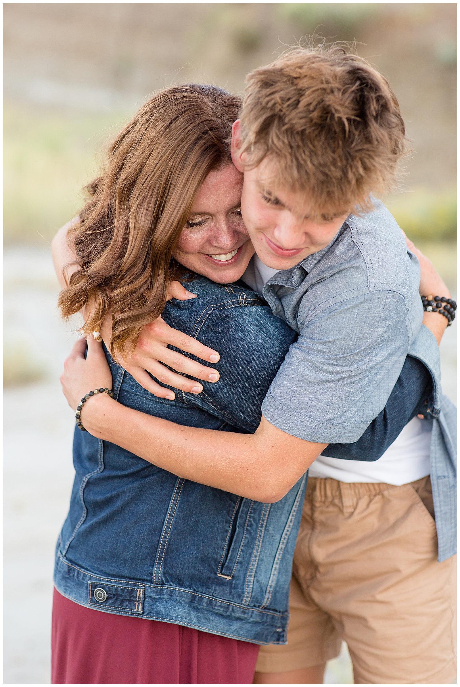 Mom hugs teen during family session by Rebecca Rice Photography in North Dakota.