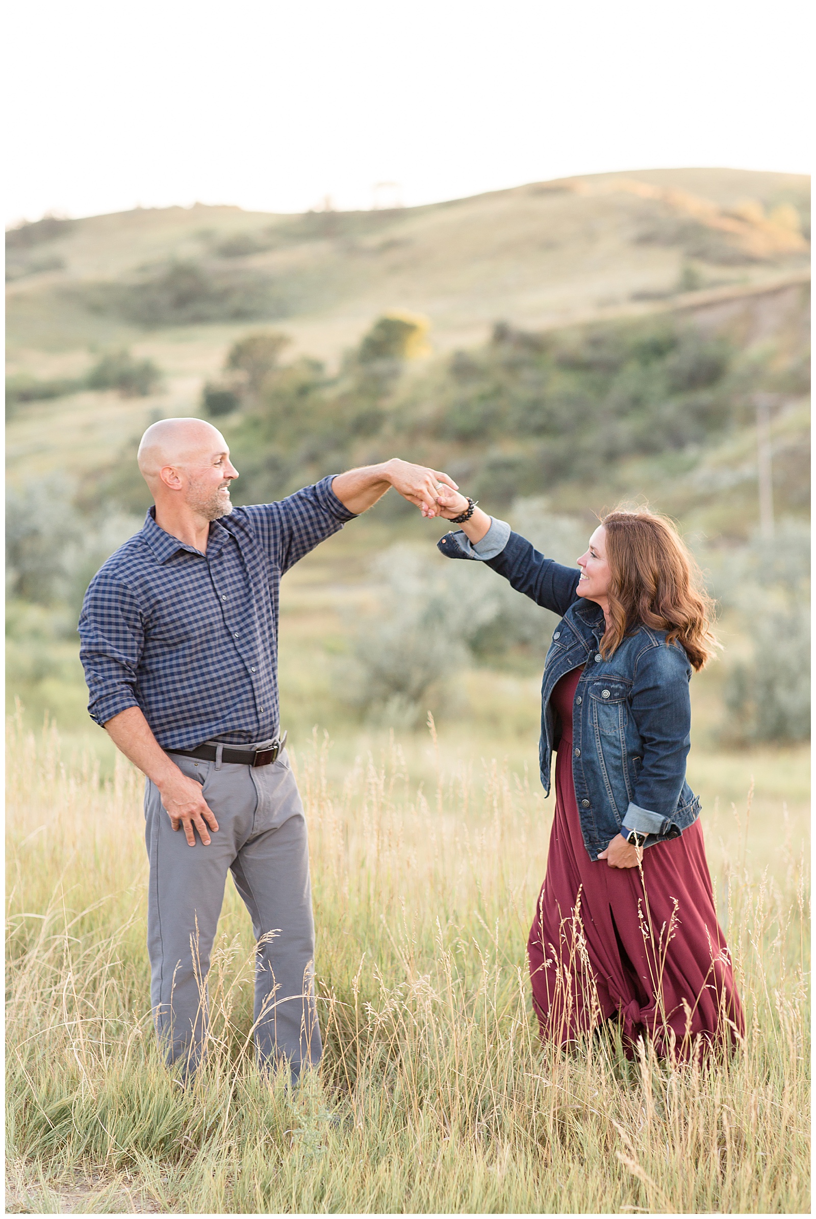 Gorgeous hills in North Dakota are the perfect backdrop for Mom and Dad to spin and dance in the open fields for Rebecca Rice Photography's camera.
