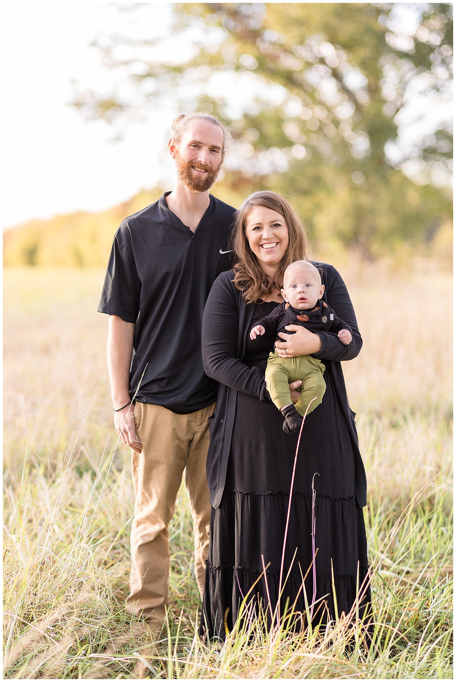 Rebecca Rice captures family of 3 in a field in Richmond, VA as a newly family of 3 wear black coordinating outfits.