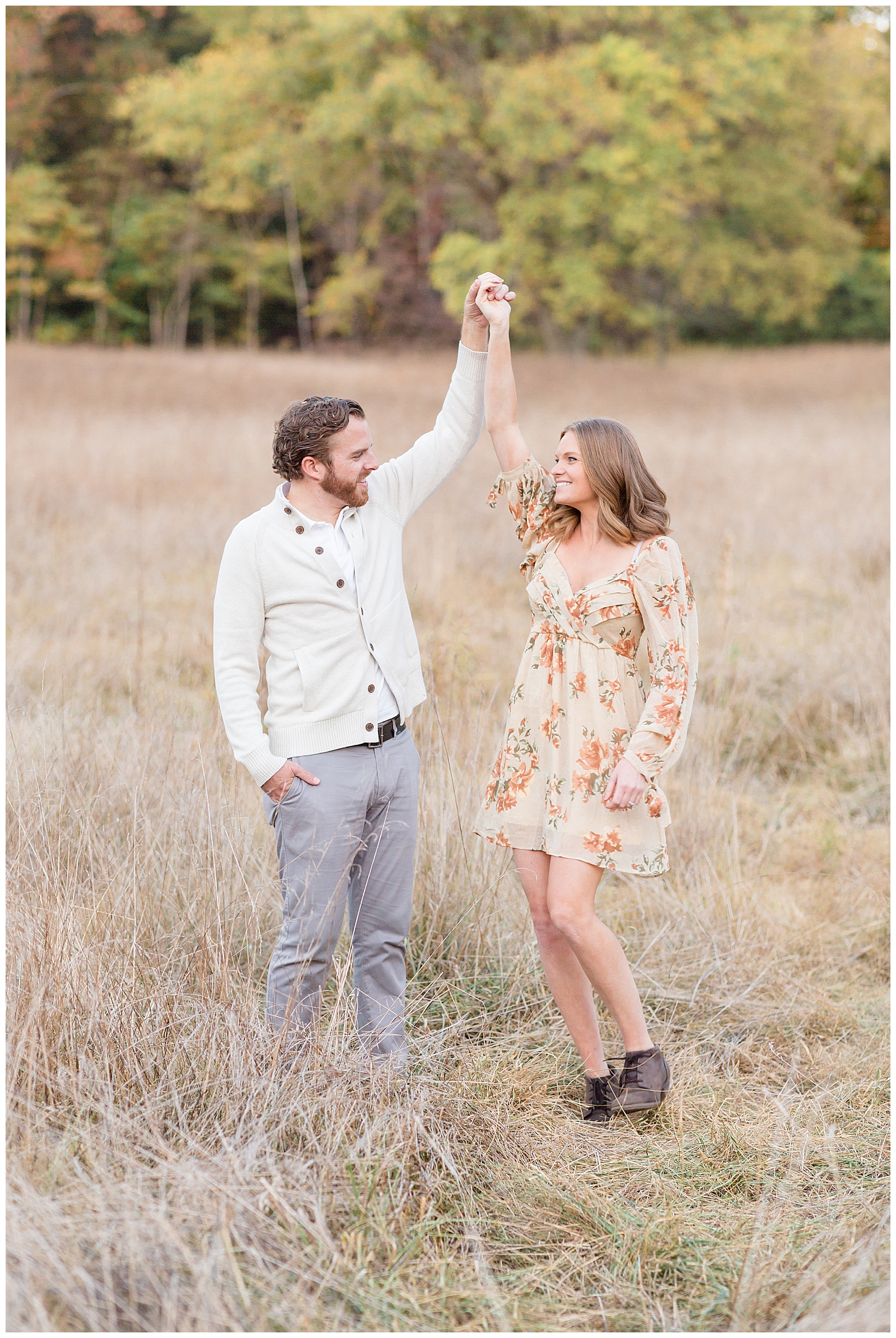 Mom and Dad share a moment together in a field in Nashville as husband twirls his wife and they look at each other while doing so.