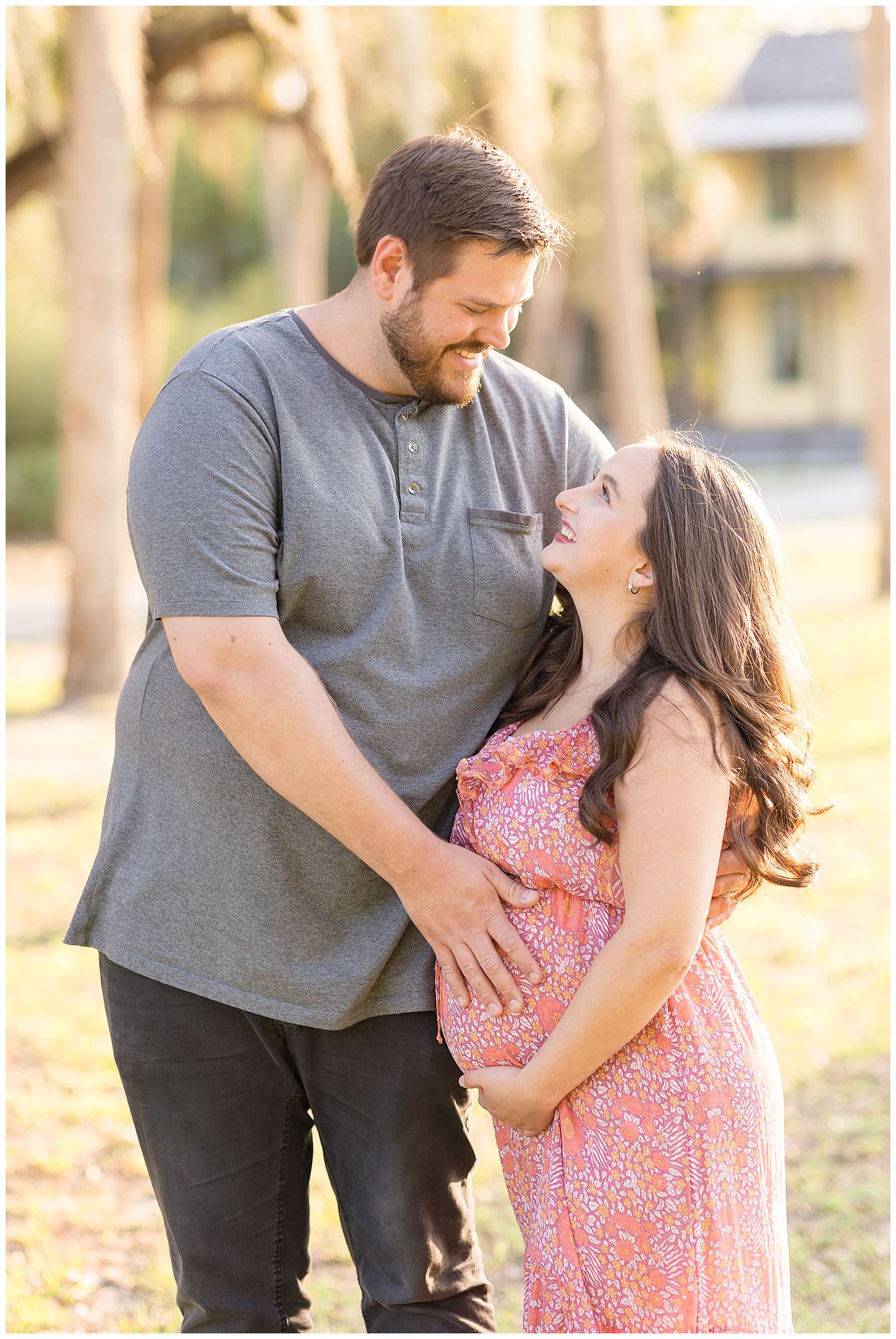 Husband with a big height difference, looks down at his wife as he holds her expecting baby belly and she looks up at him as they smile at each other! Click to see more on the blog today!
-rebeccaricephoto.com