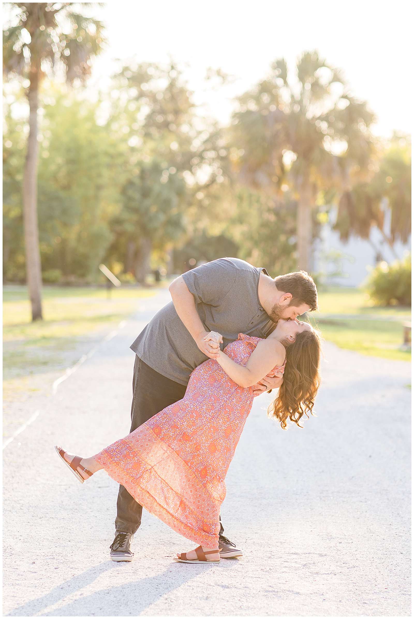 Couple stands on a Florida neighborhood street as husband dips his pregnant wife and gives her a kiss.  See more from this session on the blog today!